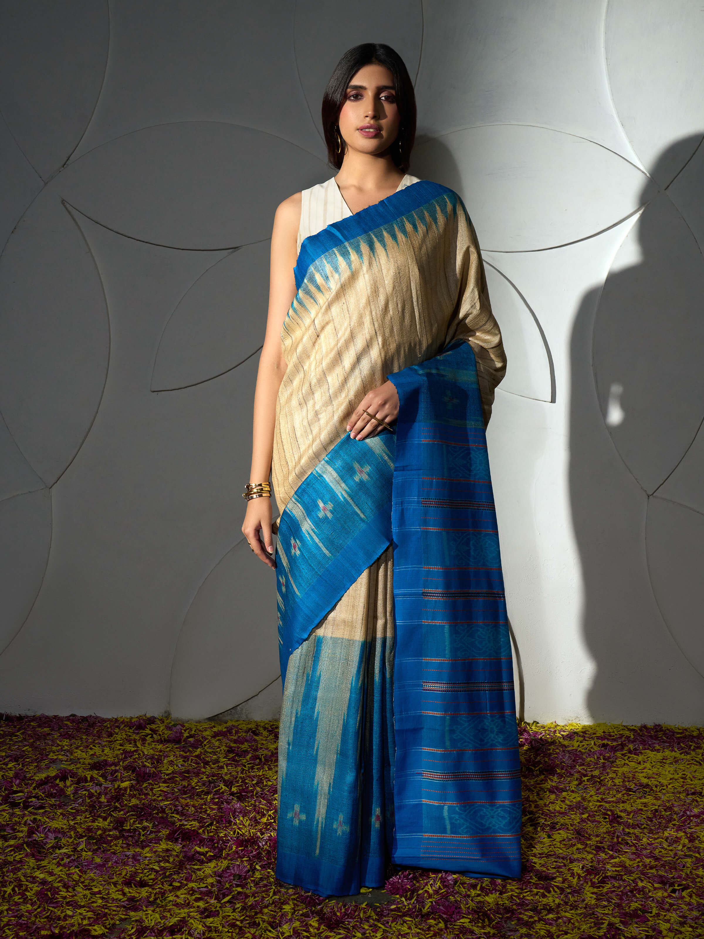 Side view of turquoise tussar ghicha silk Bandha ikat saree with elegant drape and border