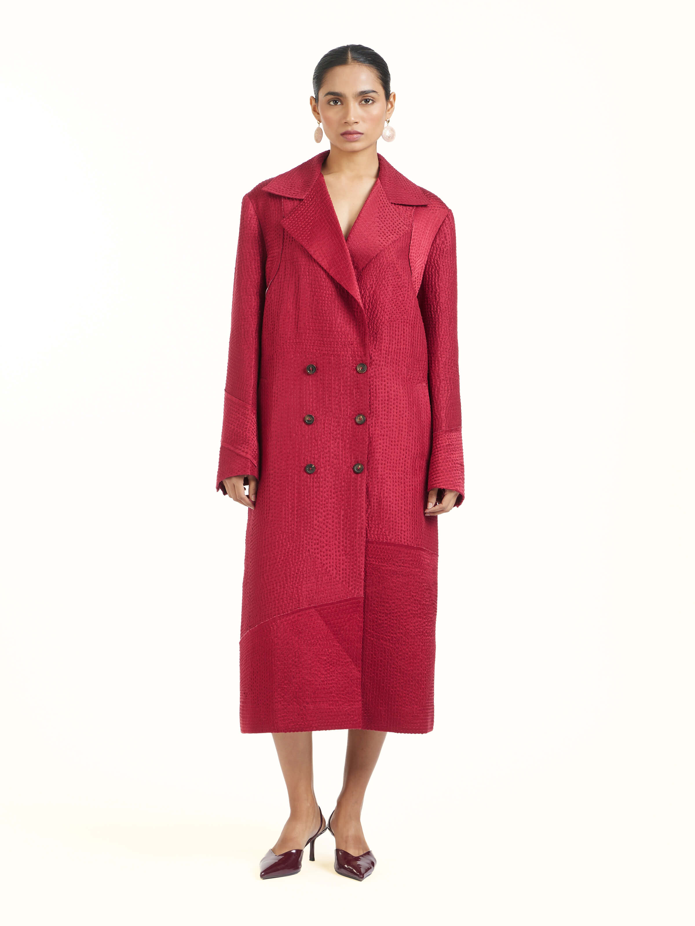 Front view of red silk kantha trench coat showcasing intricate kantha embroidery