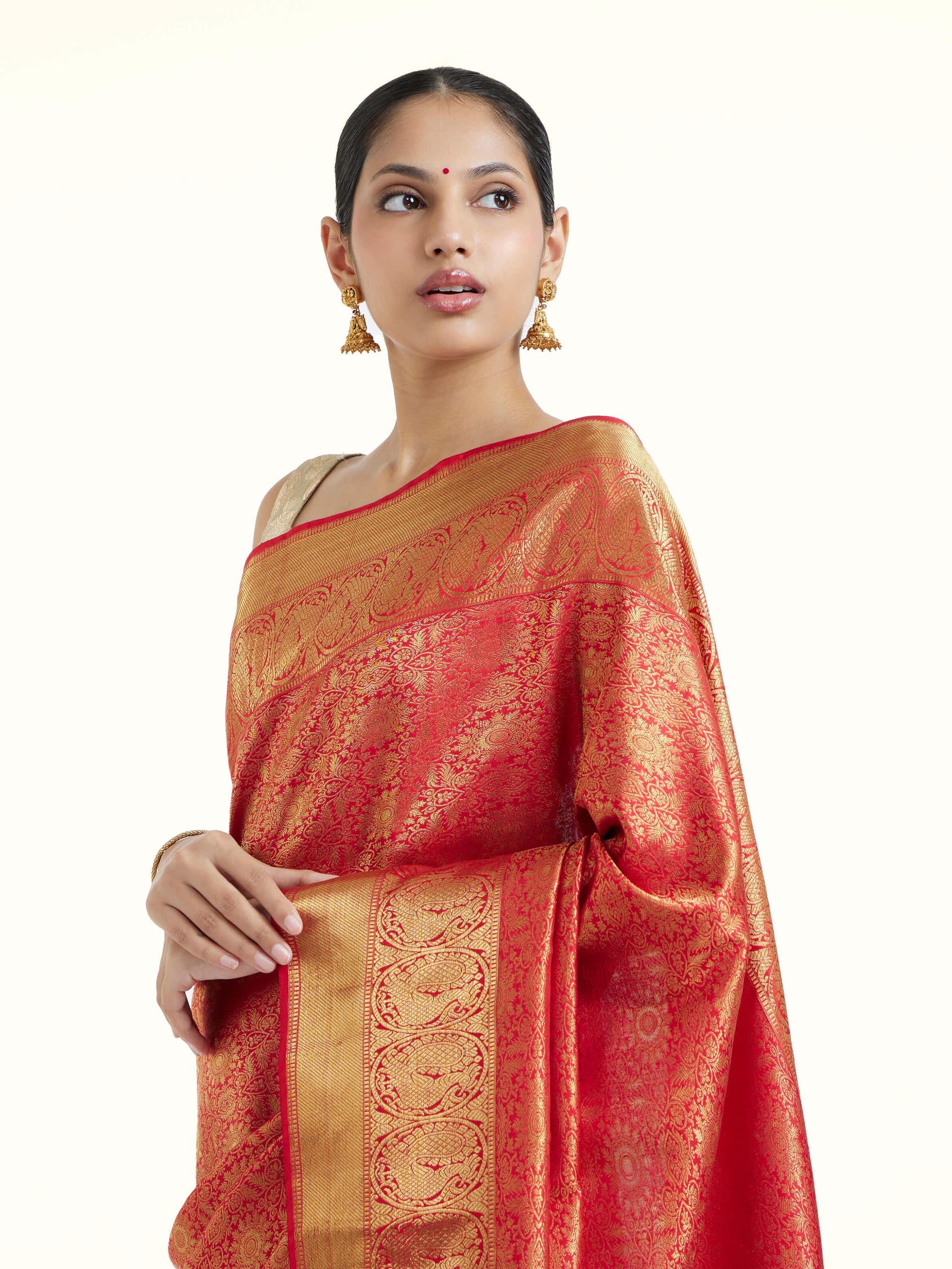 Angled view of pink silk Kancheepuram saree emphasizing traditional weave and silk sheen