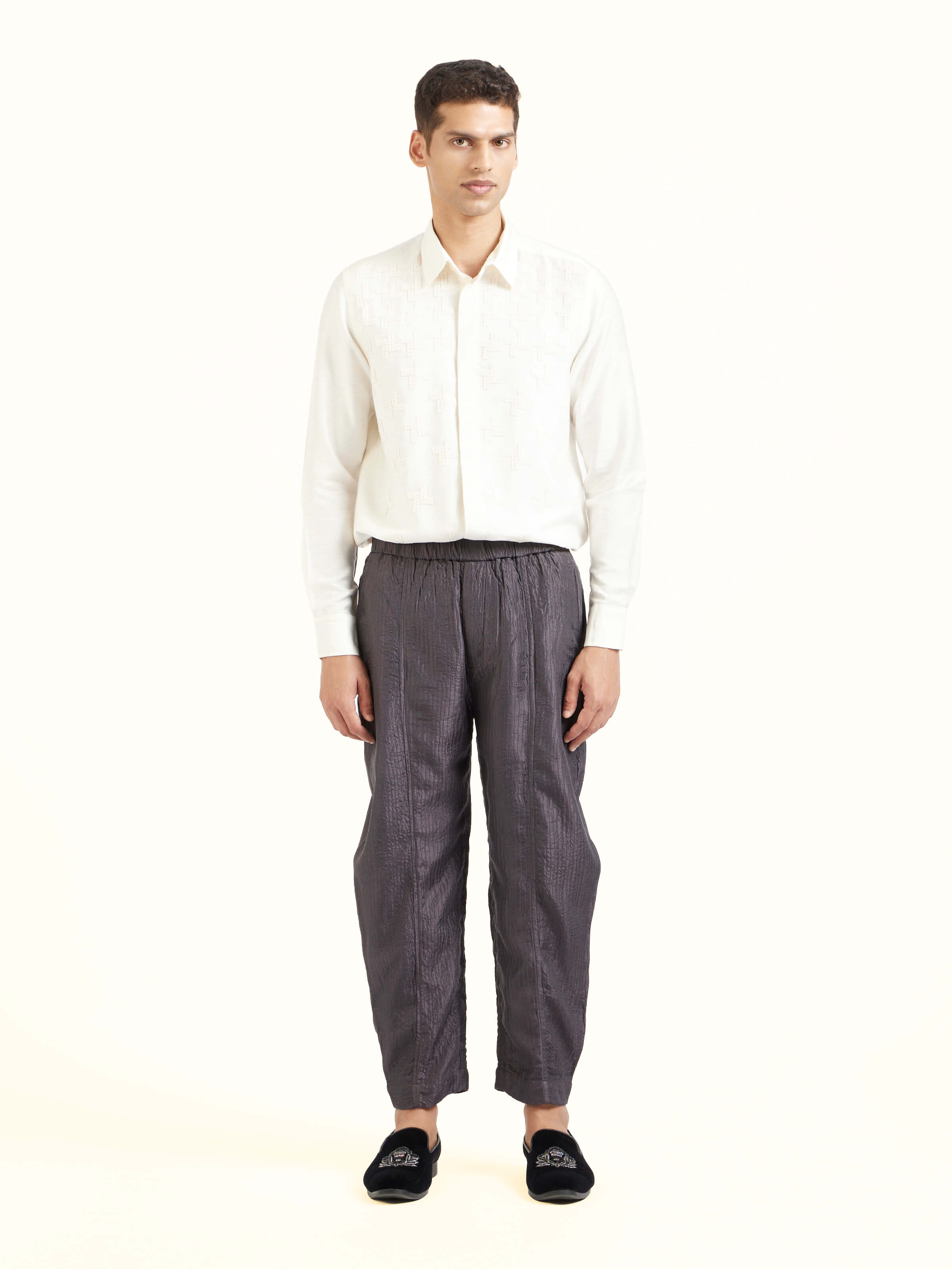 Front view of grey straight quilted tulip pure silk pants showcasing tailored fit