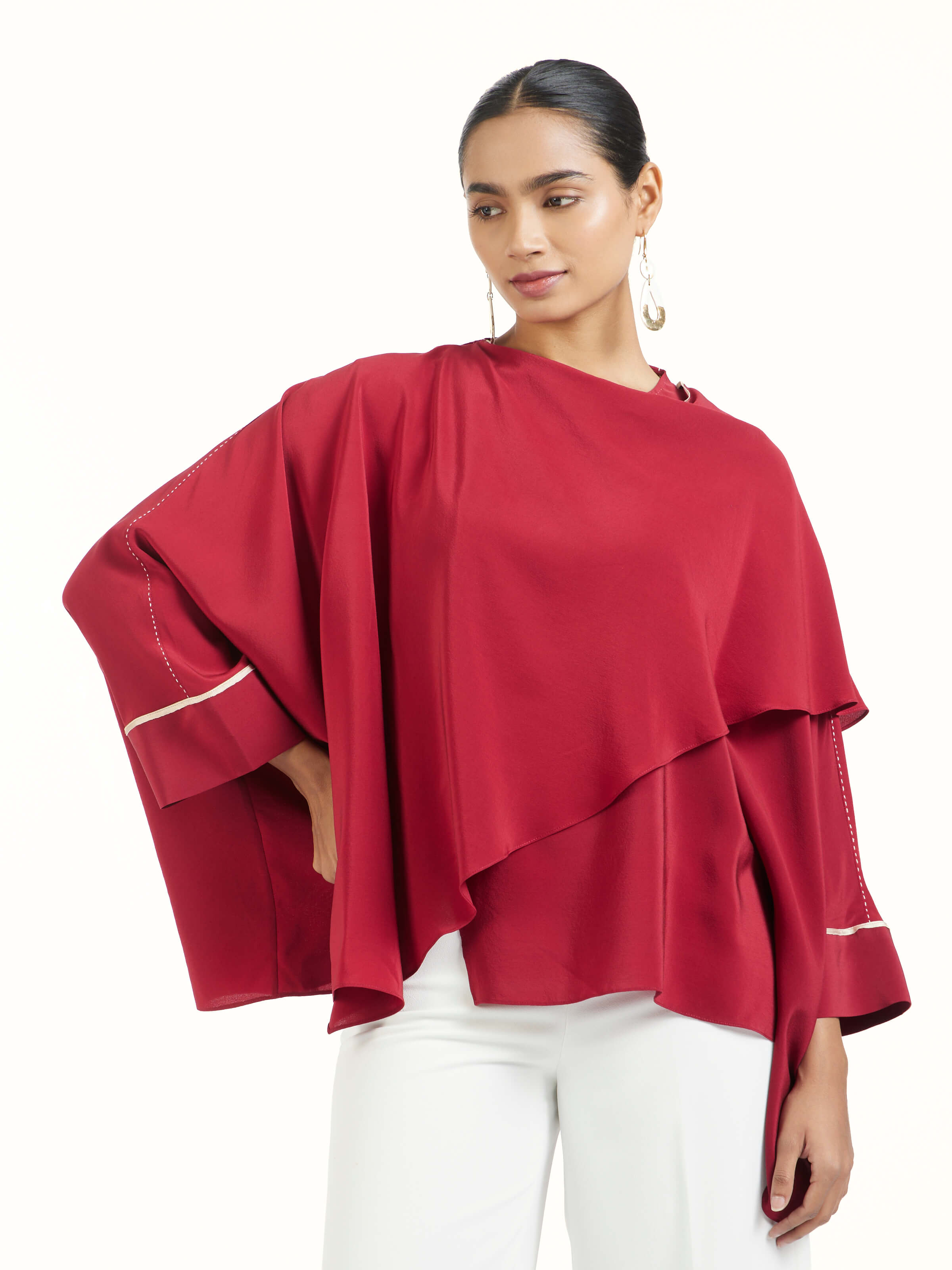 Angled view of red silk handloom top highlighting fabric texture