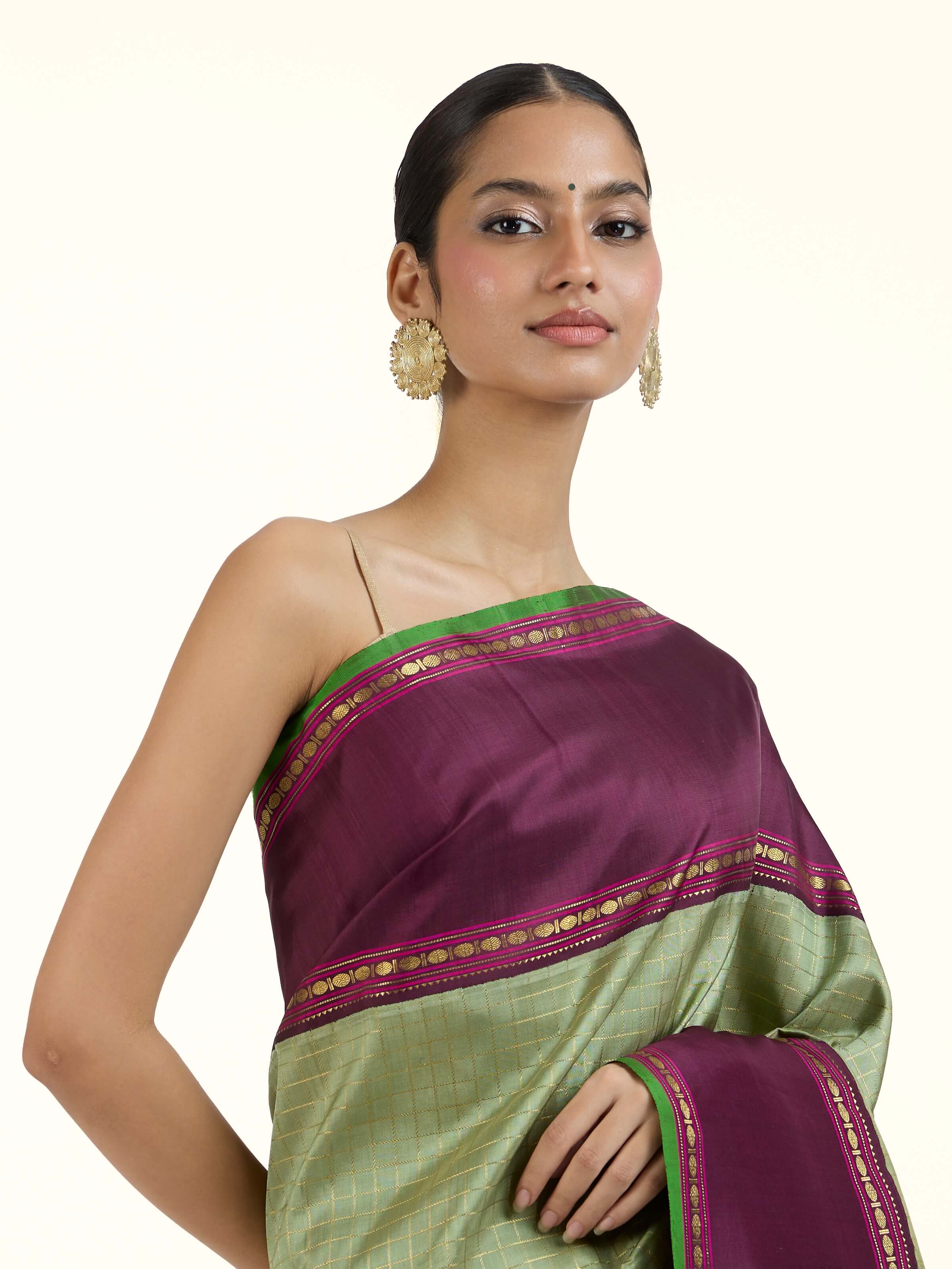 Angled view of grey silk Kancheepuram saree highlighting detailed zari work