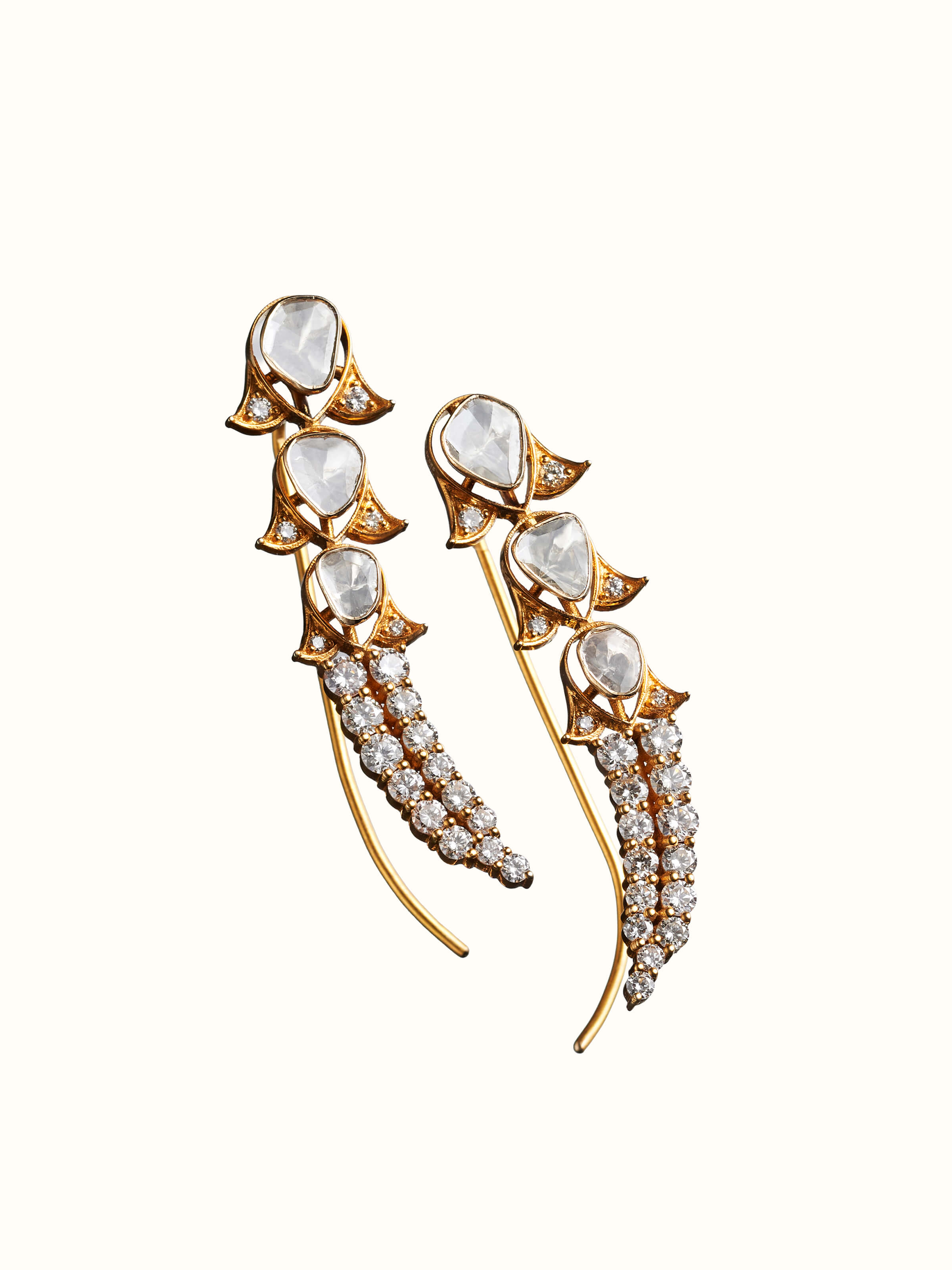 angled view of dank polki 14 karat gold drop earrings