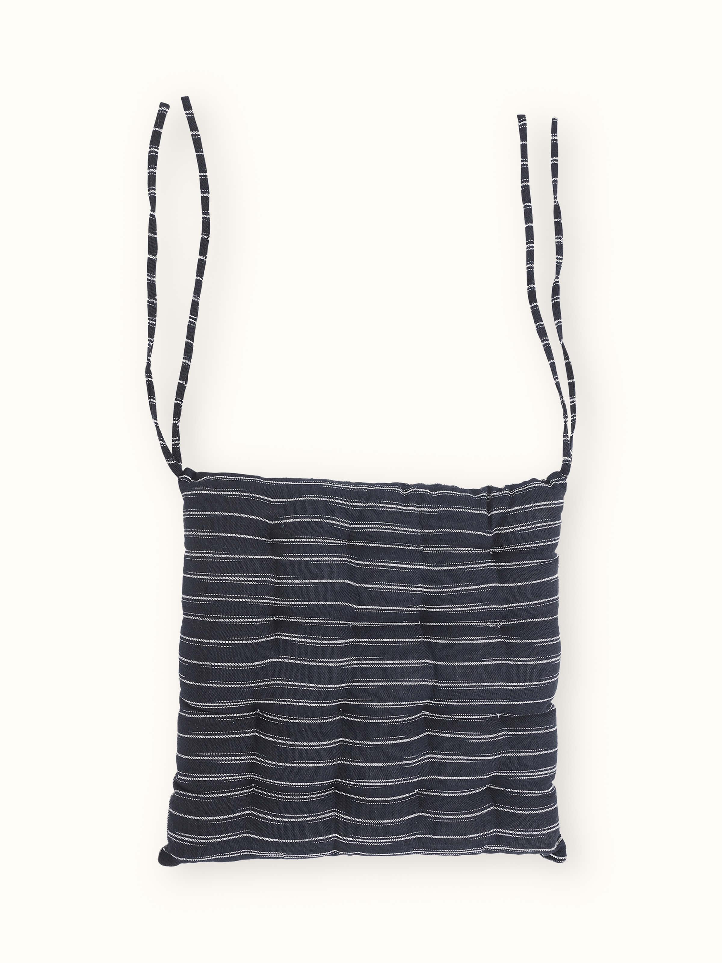 Angled product image of Krsna black handloom cushion for chair seating – simple and functional