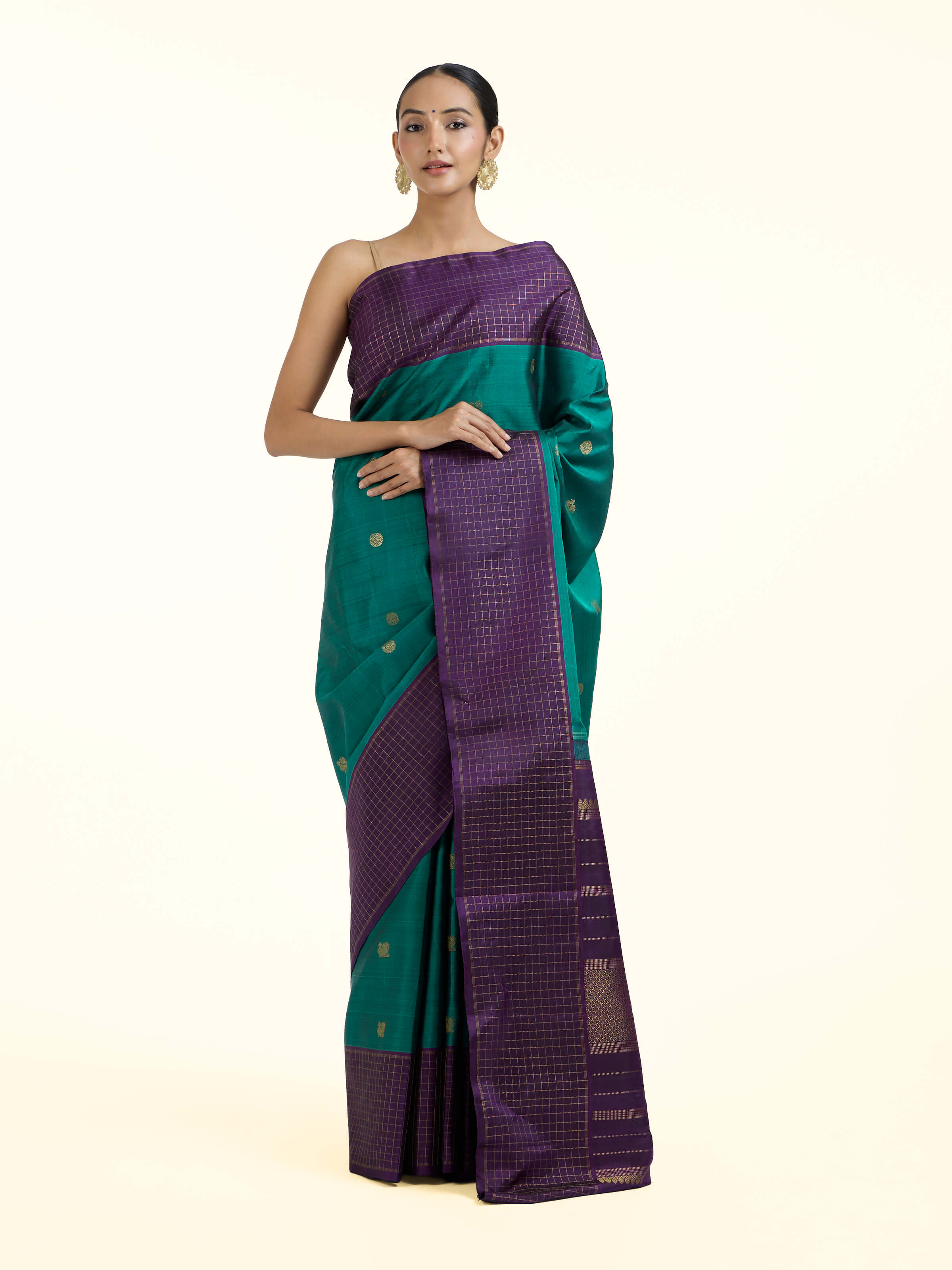 Front view of green silk Kancheepuram saree with rich zari woven motifs