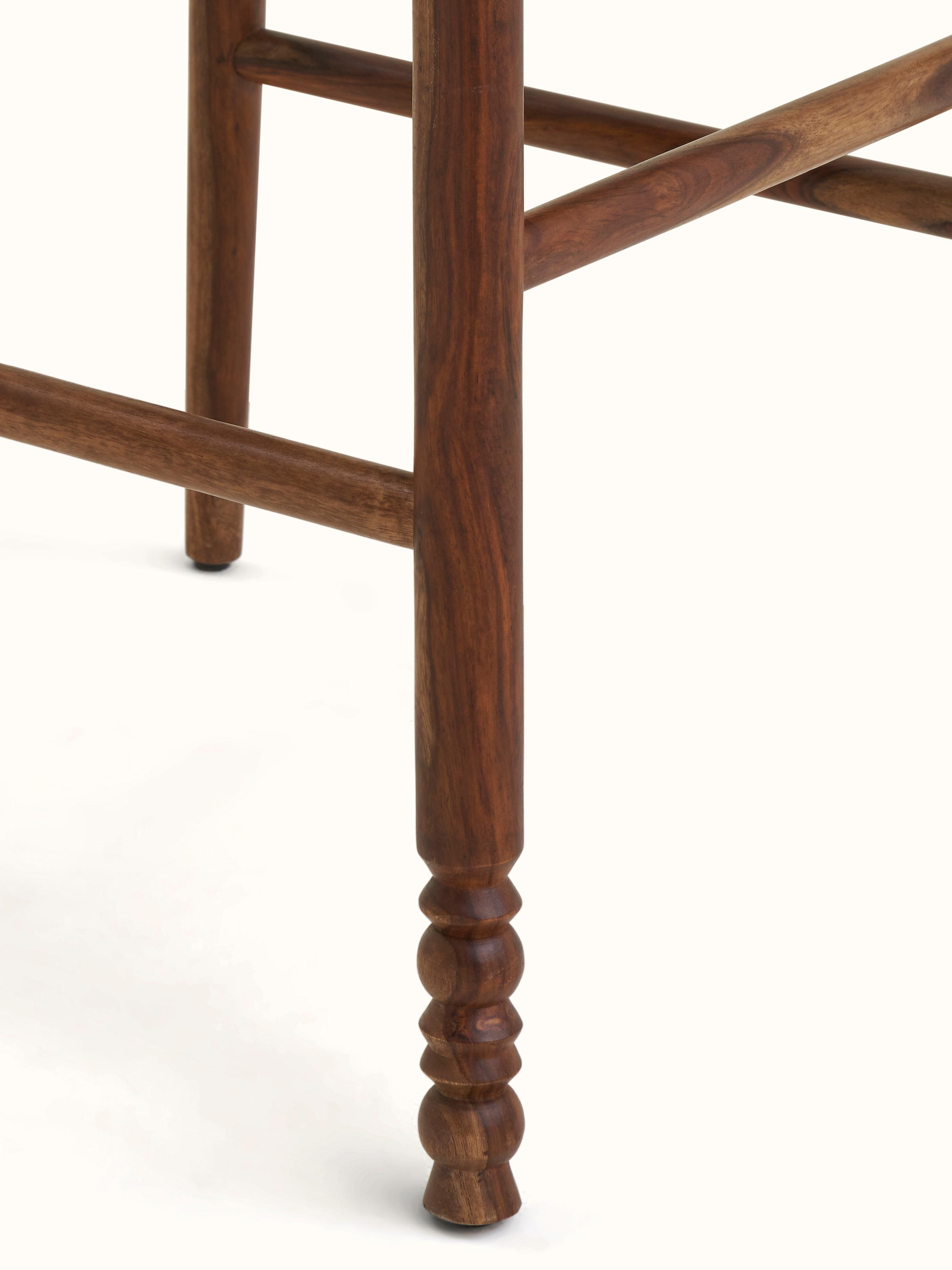 Close-up view of the Upholstered Sheesham Wood Bawan Buti Bar Stool emphasizing fabric texture