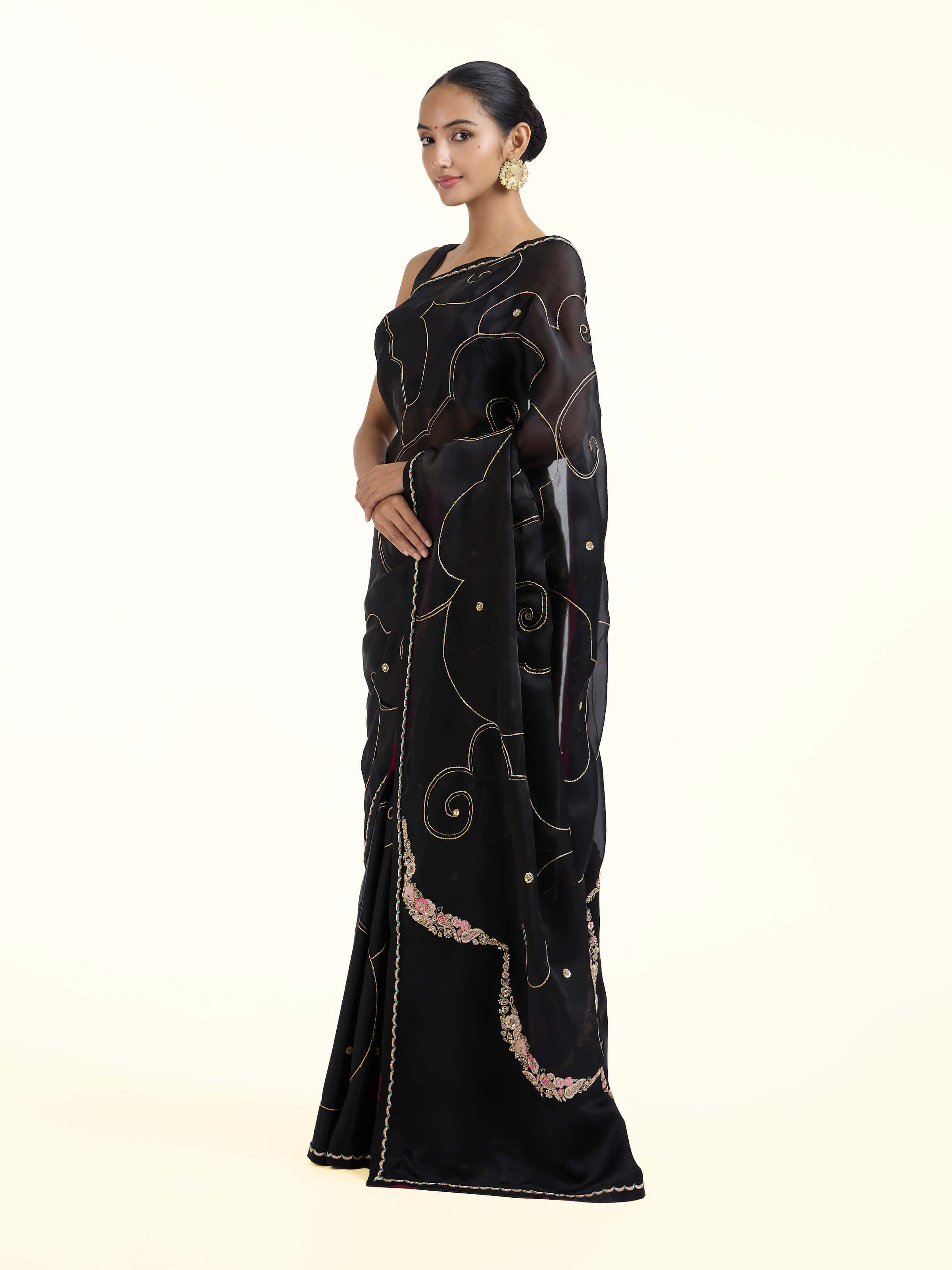 Side view of black silk zardozi saree with elegant drape