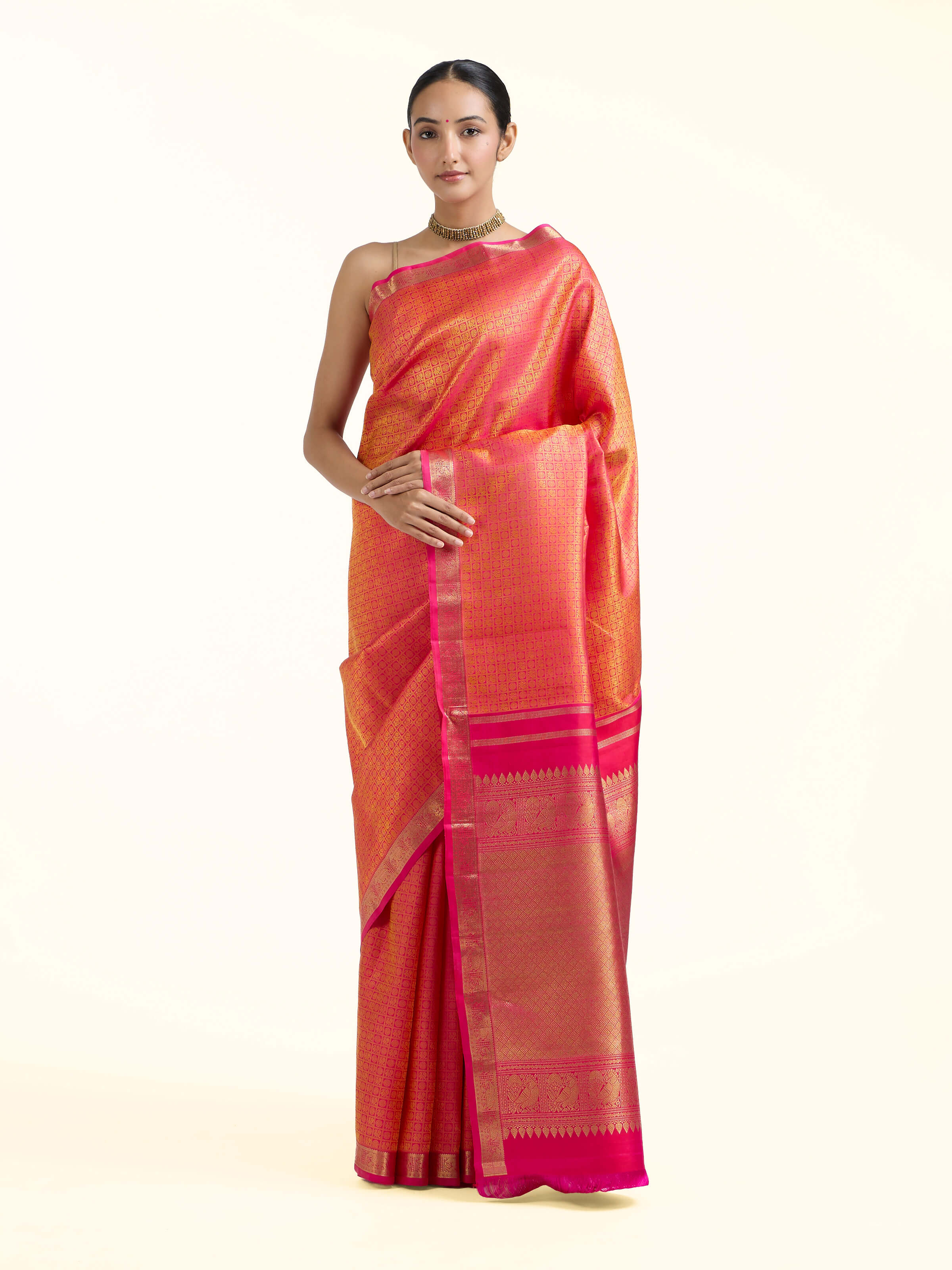 Front view of orange silk Kancheepuram saree with rich zari woven motifs