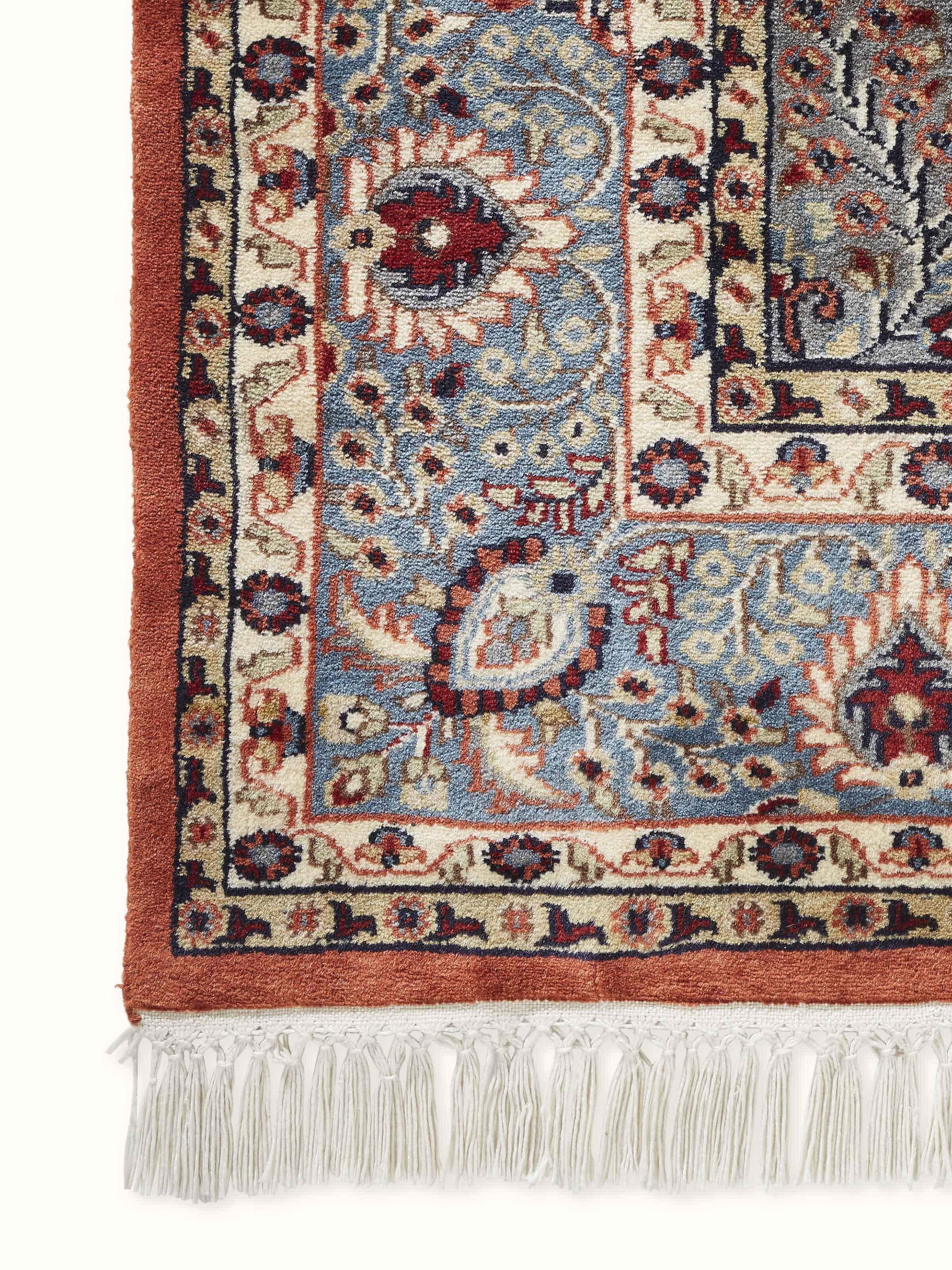 A side angle of the carpet highlights the dense wool pile and texture, reflecting skilled craftsmanship.