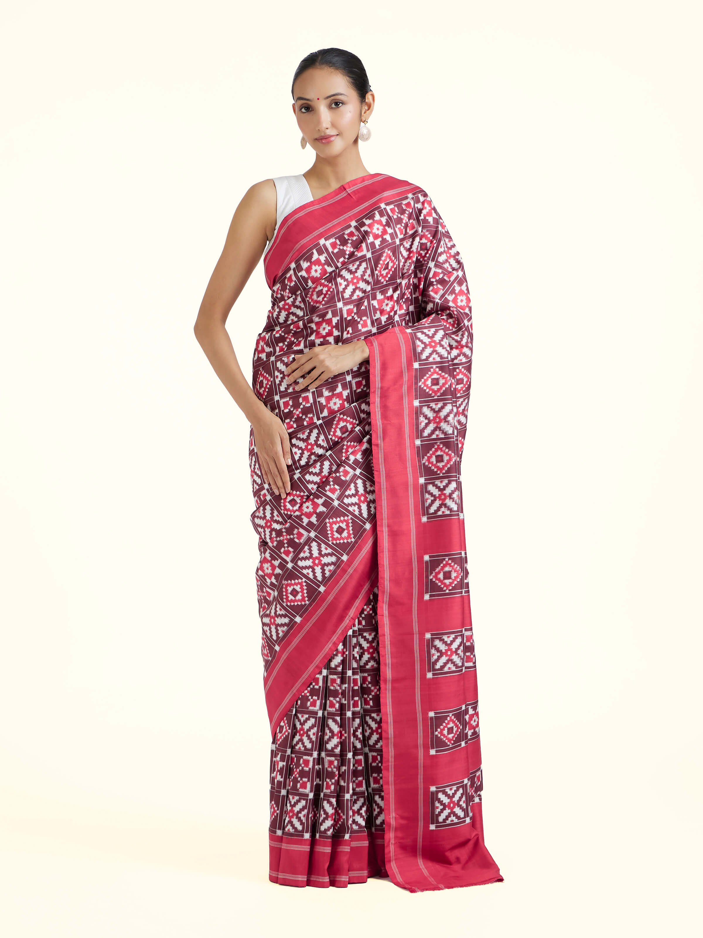 Front view of red mulberry silk Ikat saree showcasing vibrant hue and traditional Ikat patterns