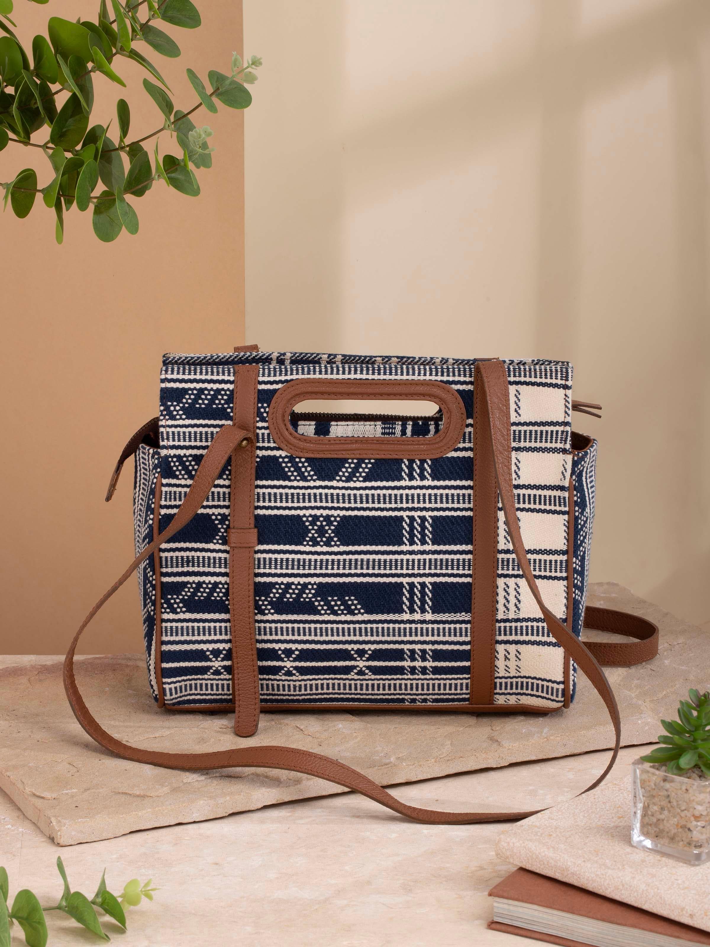 Woman carrying extra-weft sling bag with leather flap in a casual setting.