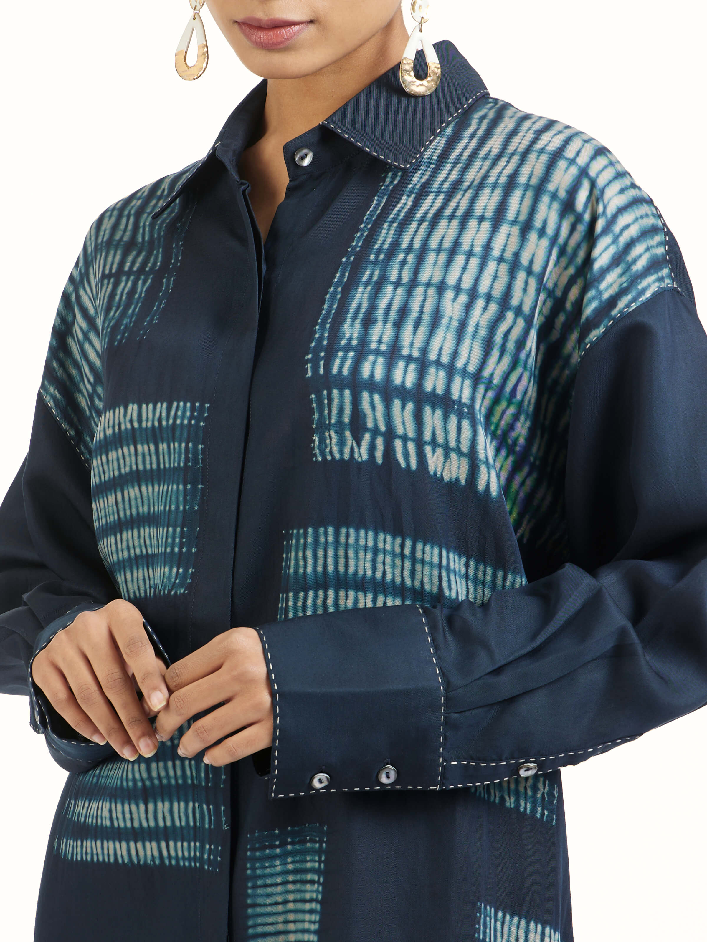 Detail view of blue shibori long shirt showing fabric texture and print
