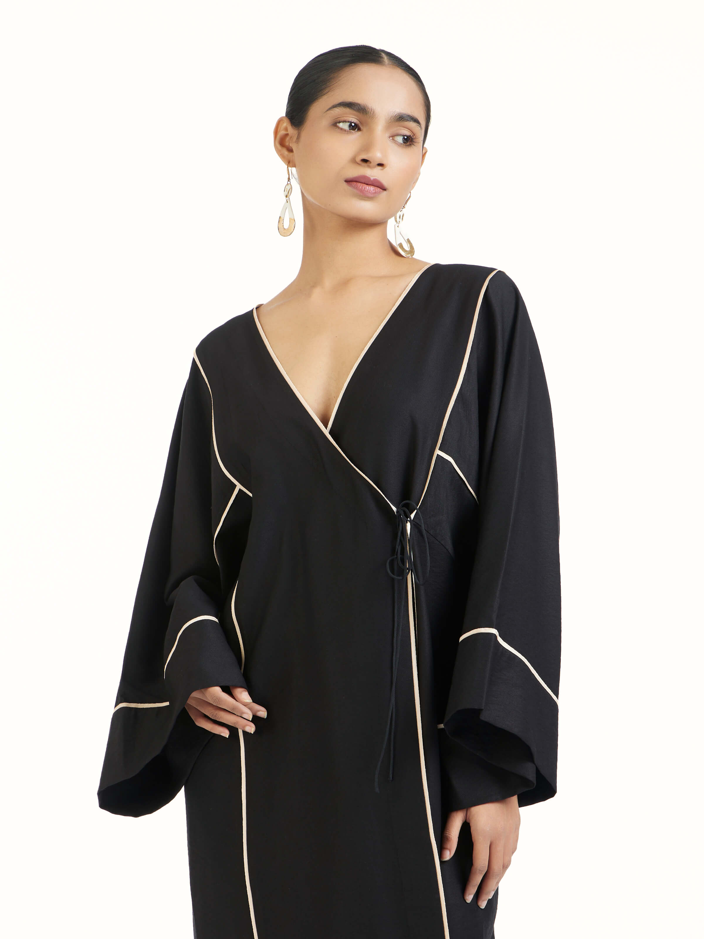 Angled view of black shibori kimono dress highlighting shibori dye work