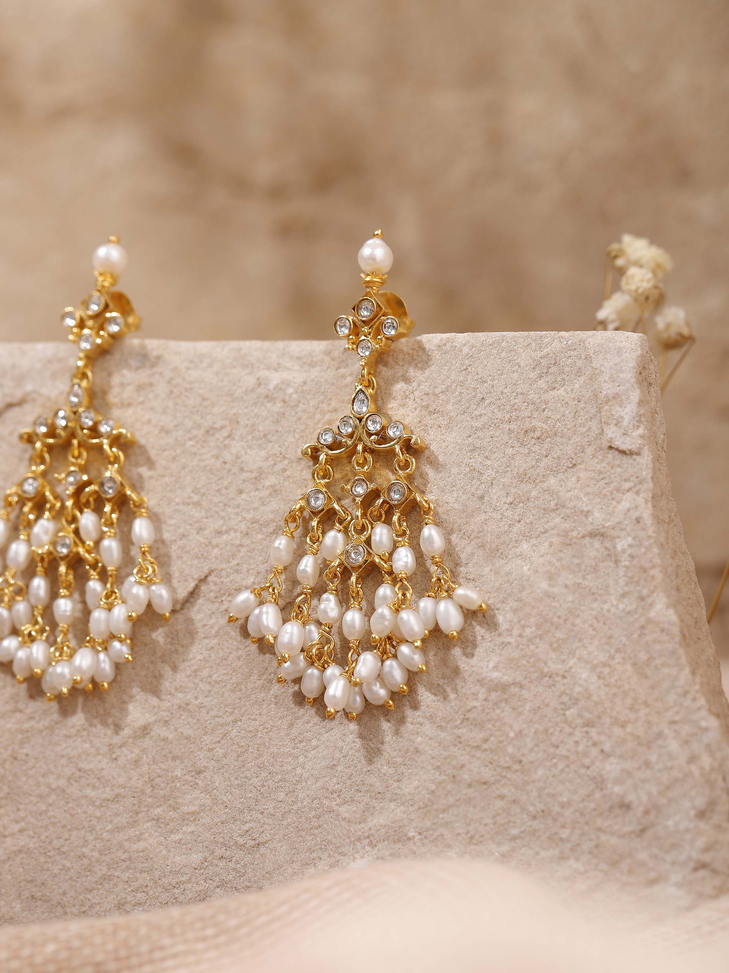 Alternate lifestyle angle capturing the graceful drop and traditional design of the earrings from a different perspective.