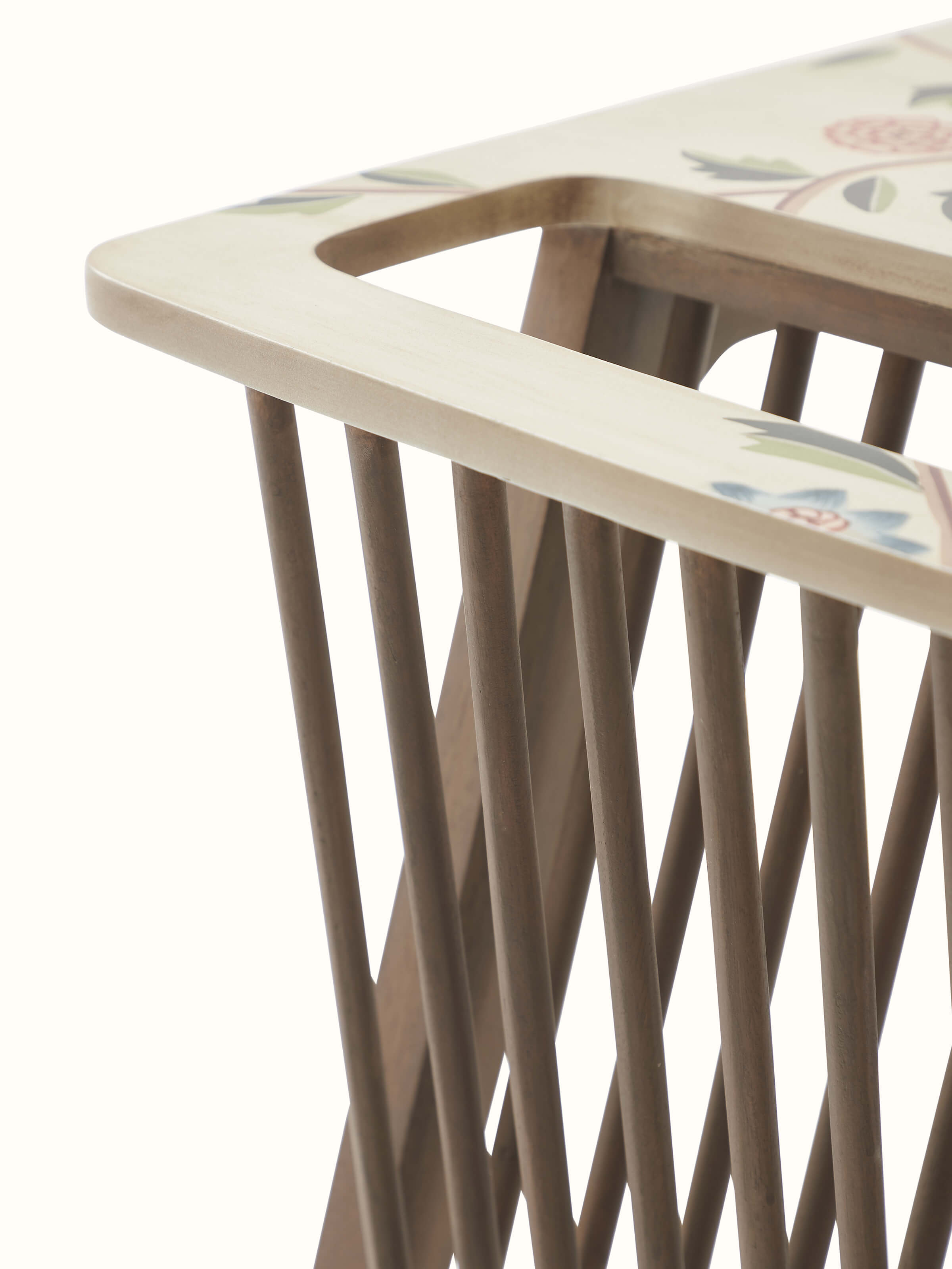 Angled view of the mango wood magazine rack showcasing its miniature painting and functional design.