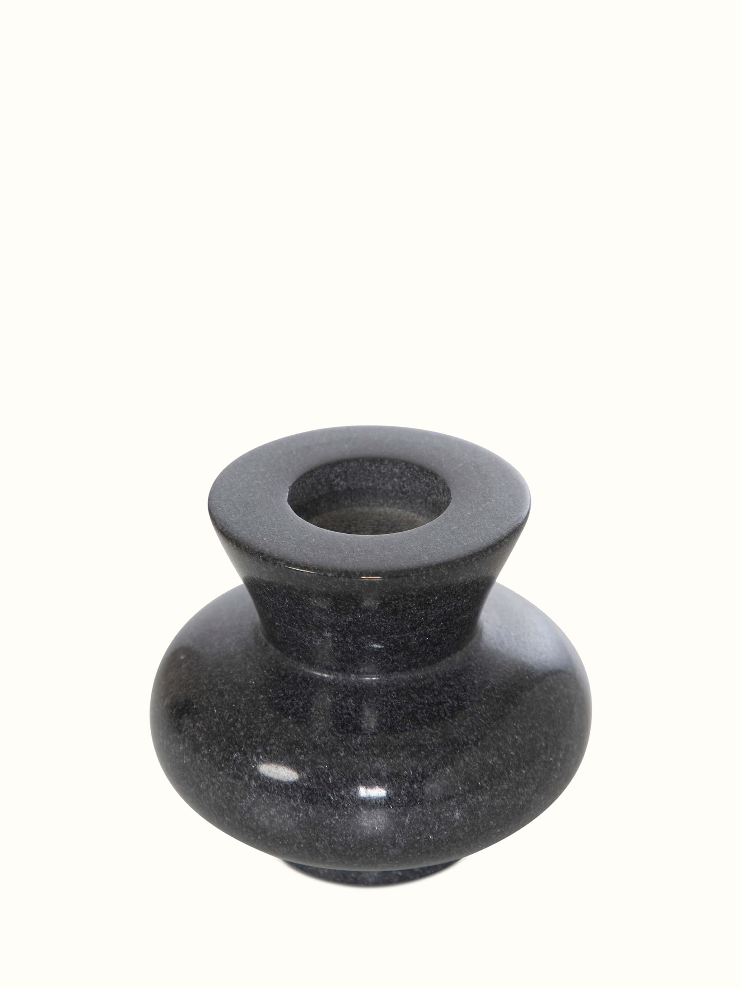 Close-up view of Carved marble tea light holder in black color focusing on detailed carvings and texture.