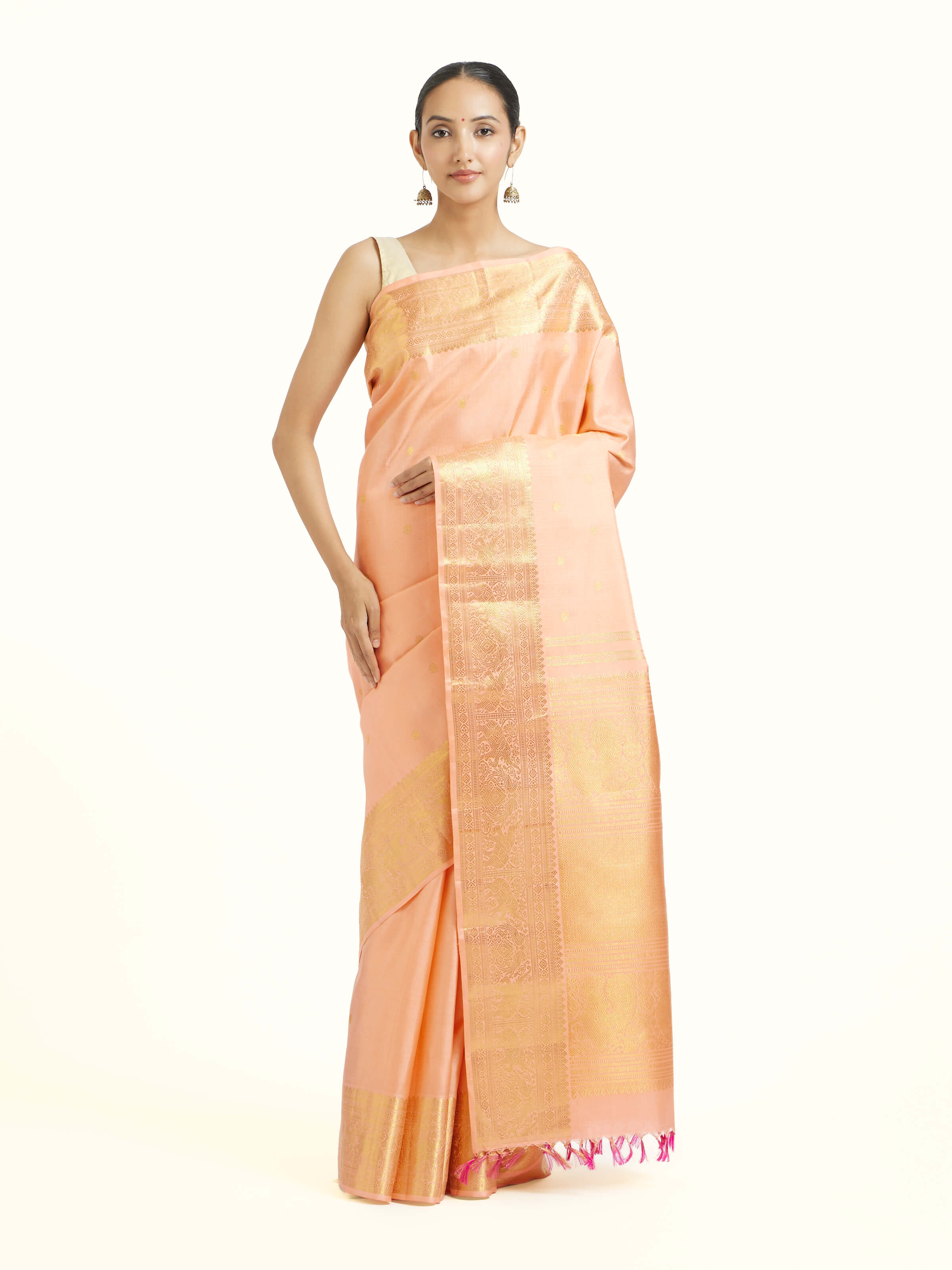 Front view of light pink silk Kancheepuram saree with delicate zari motifs