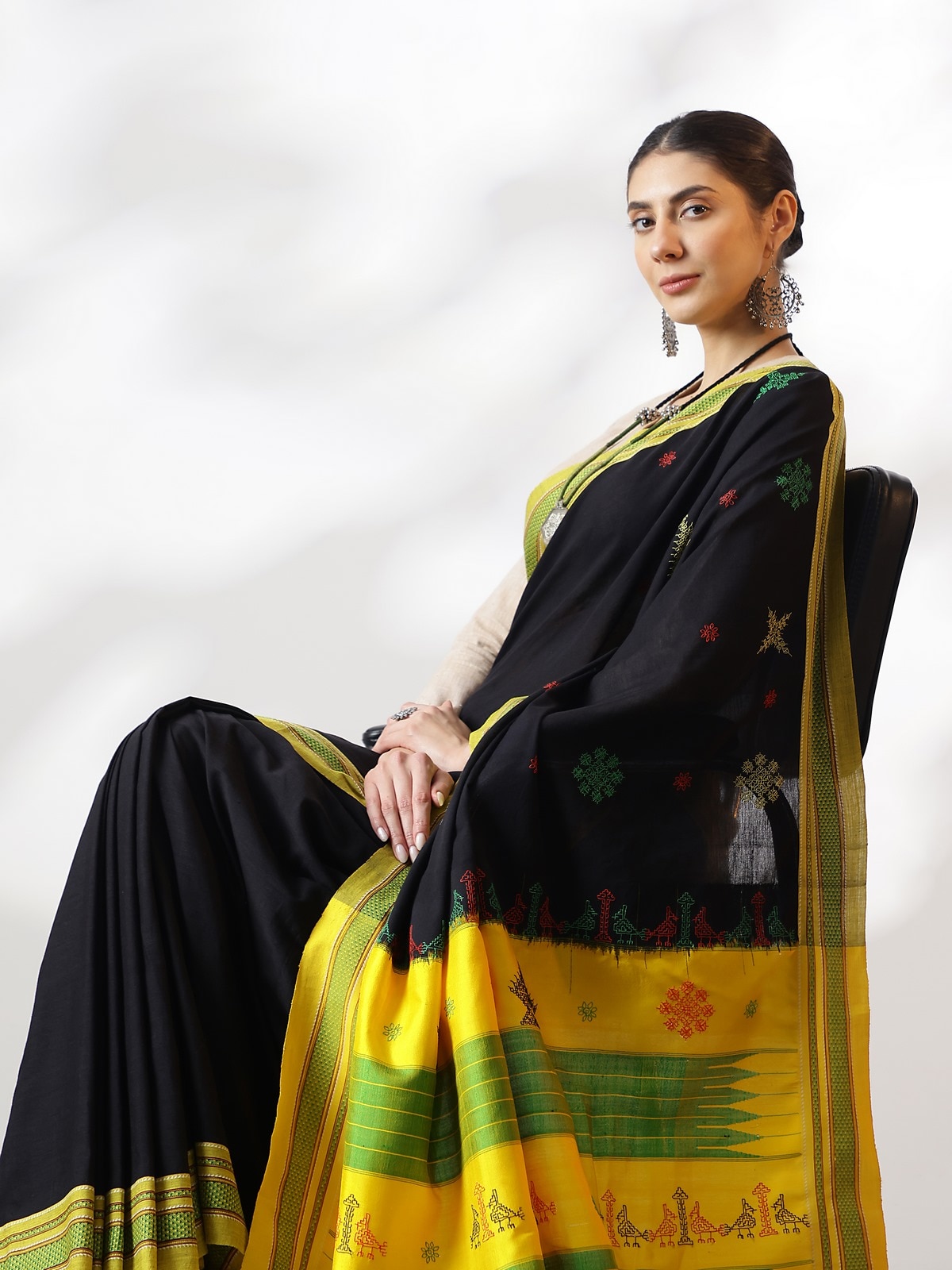 Side view of black cotton silk Kasuti embroidered saree with ornate border and pattern