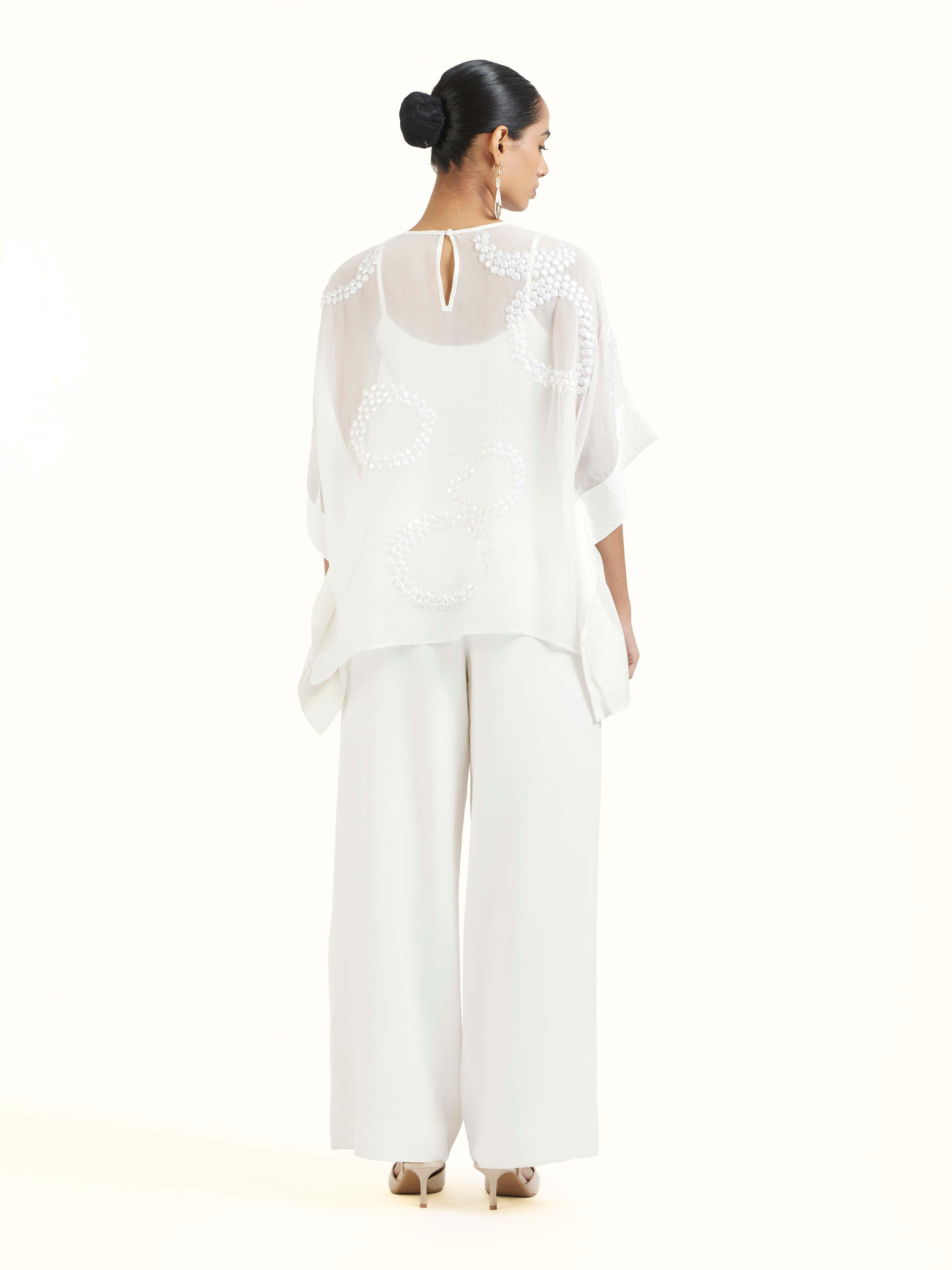 Back view of ivory hand embroidered organza kaftan displaying elegant design continuity