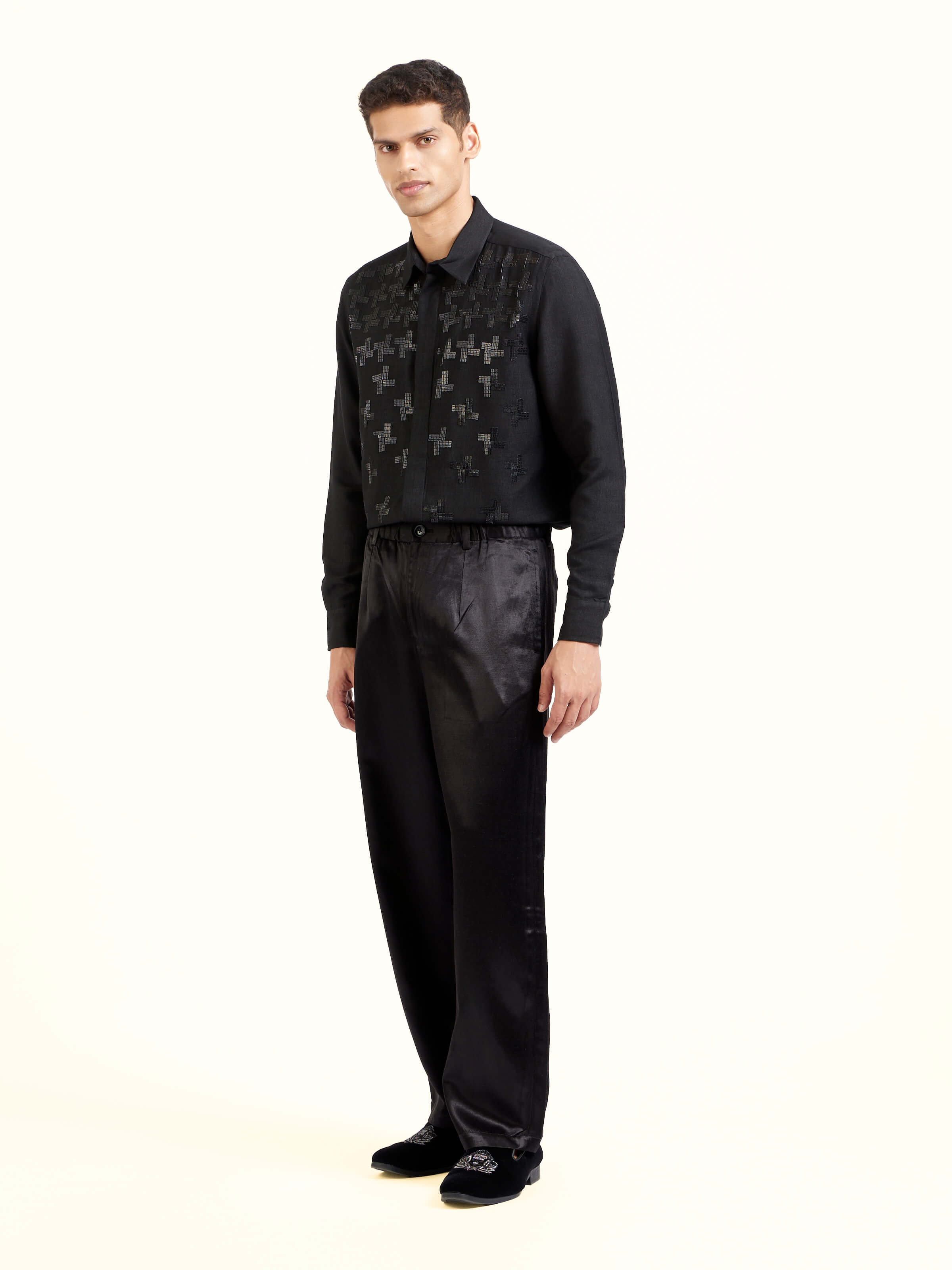 Side view of black straight cut mashru pants highlighting straight silhouette and fall