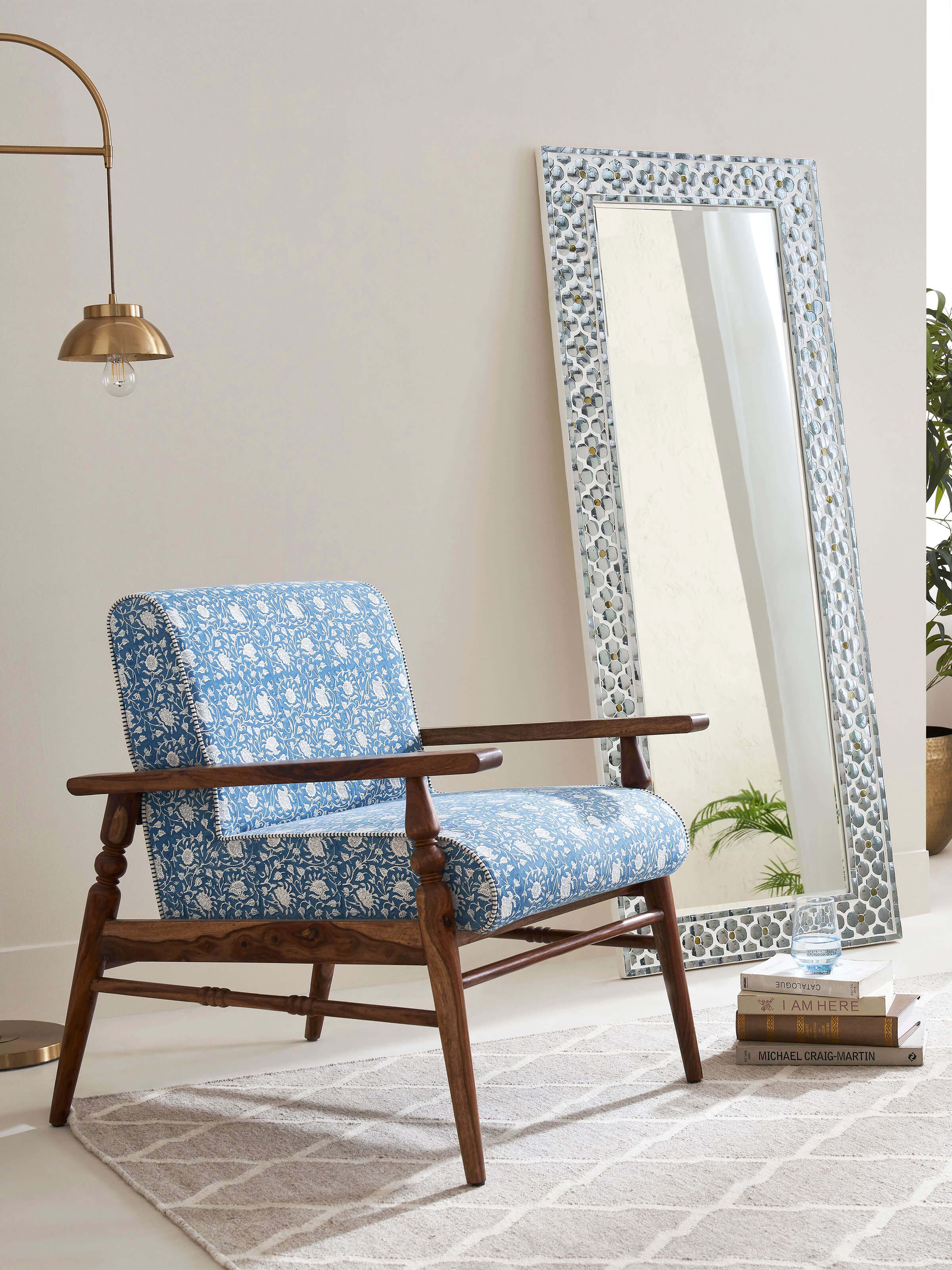 Side view of the Sheesham wood Sanganeri block print armchair, showing the profile and design of the armrests.