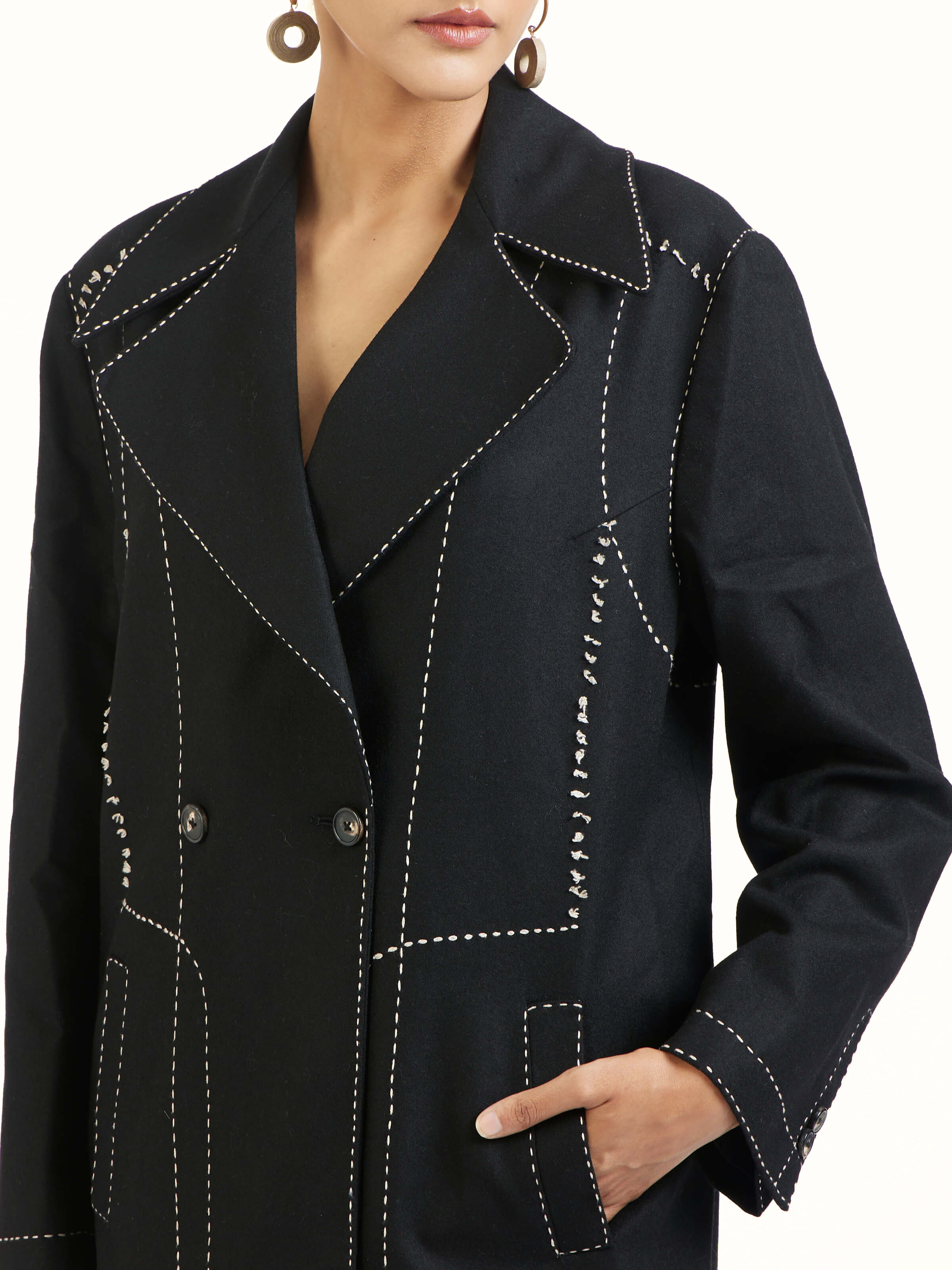 Detail view of black wool kantha jacket showing embroidery texture and fabric