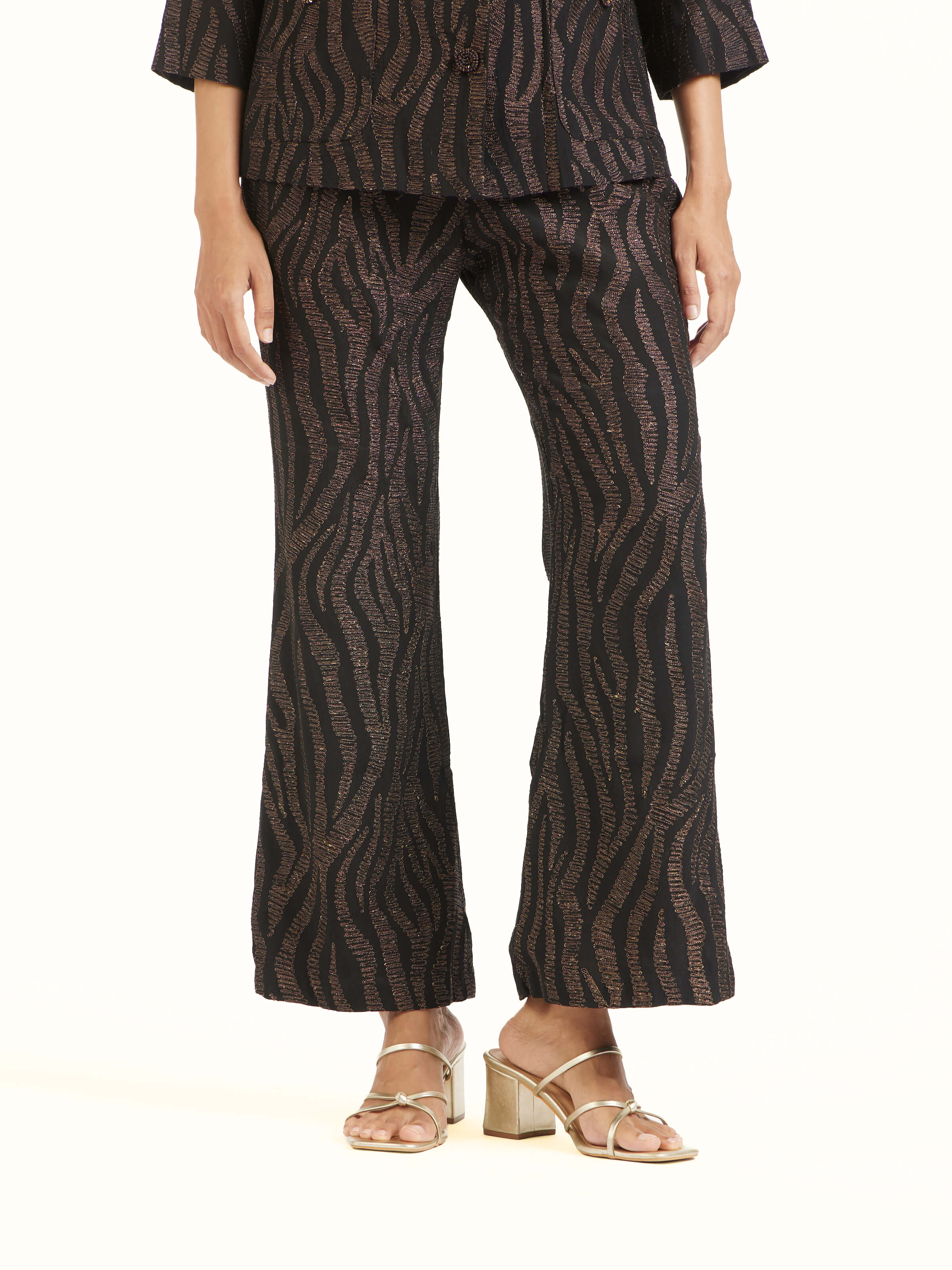 Angled view of black Aari hand embroidered pants highlighting embroidery details