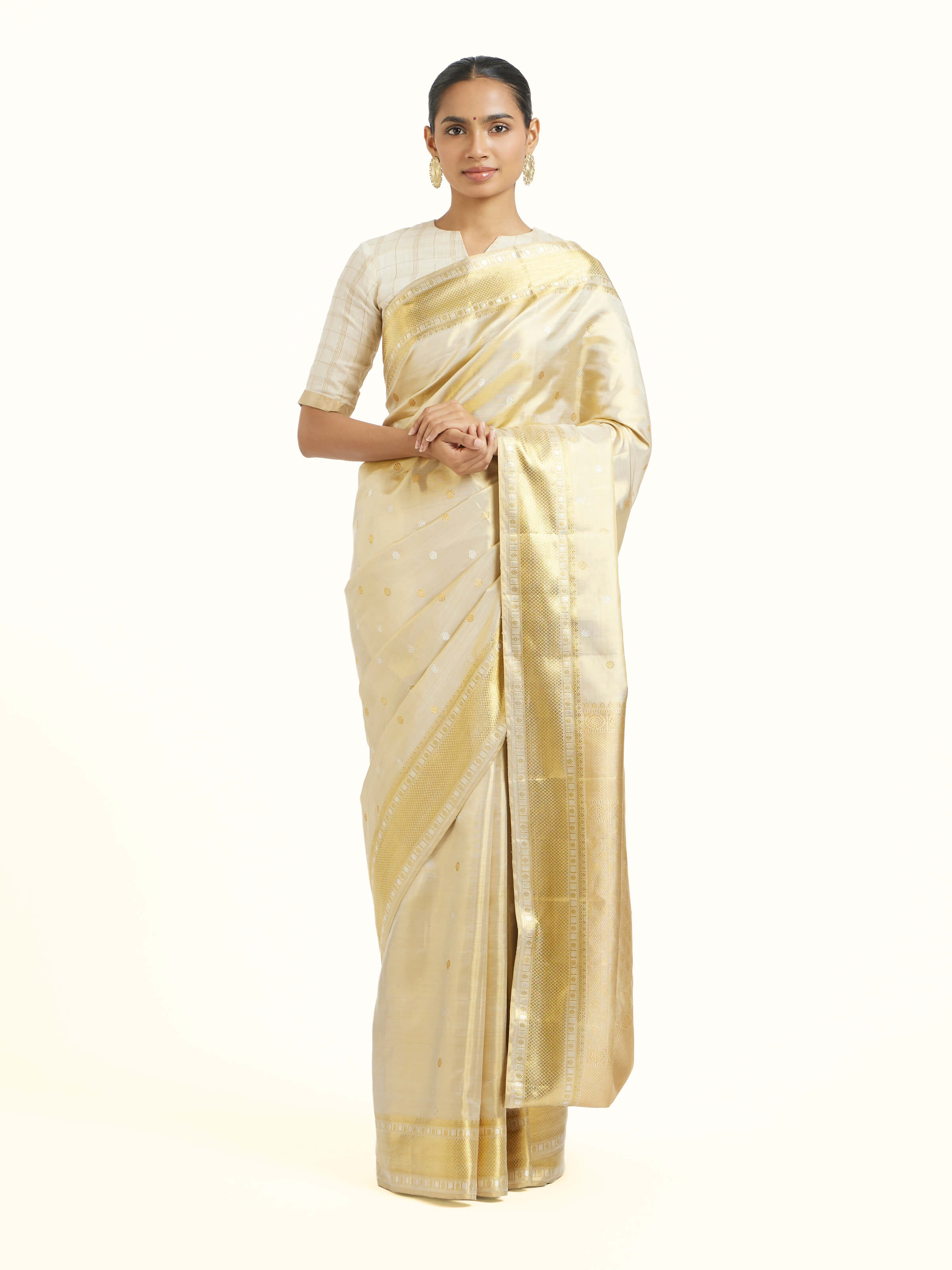 Front view of beige silk Kancheepuram saree with rich zari woven motifs