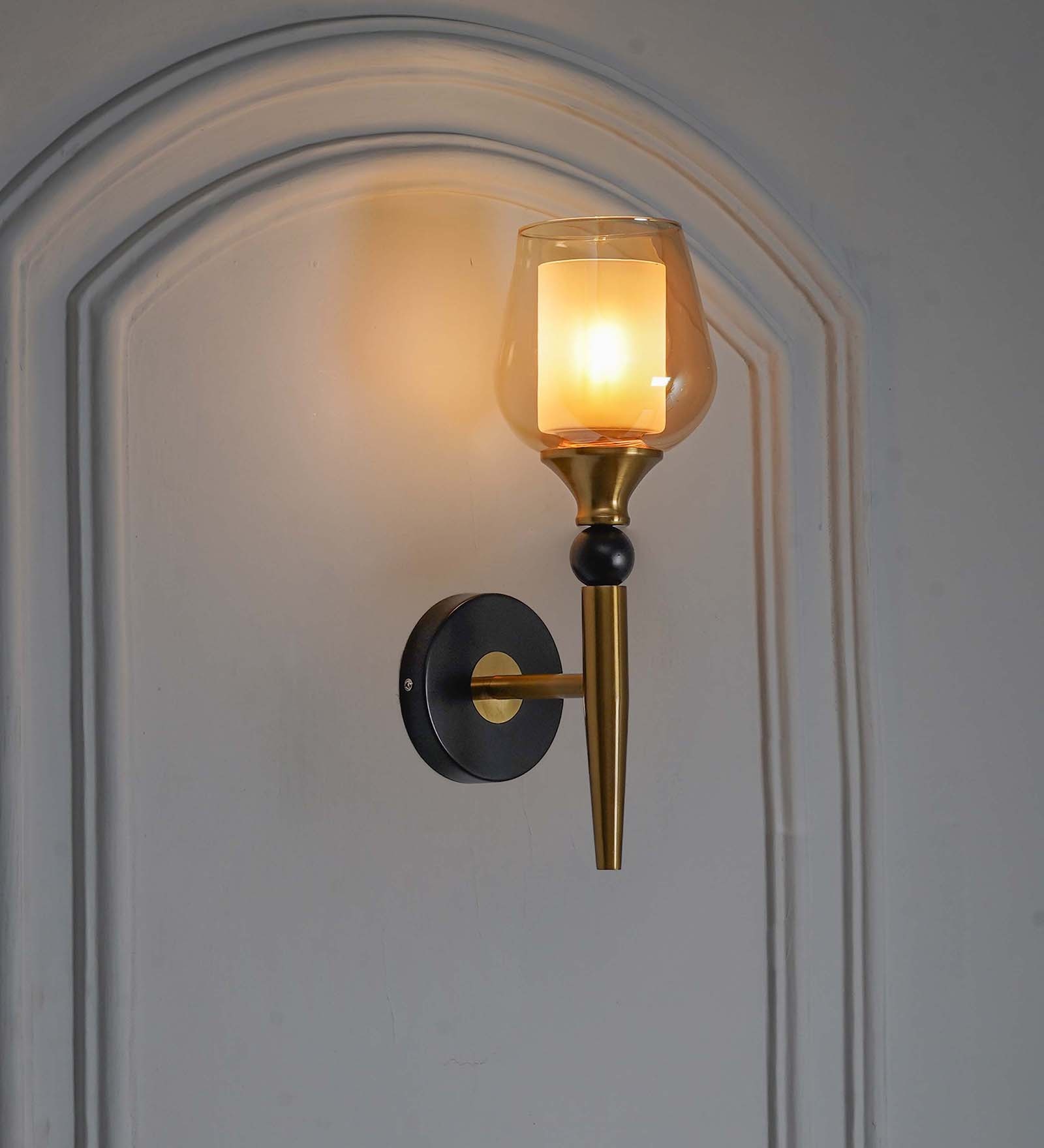 Mantis Single Light Wall Fitting In Black And Brass Finish Metal With Amber Glass