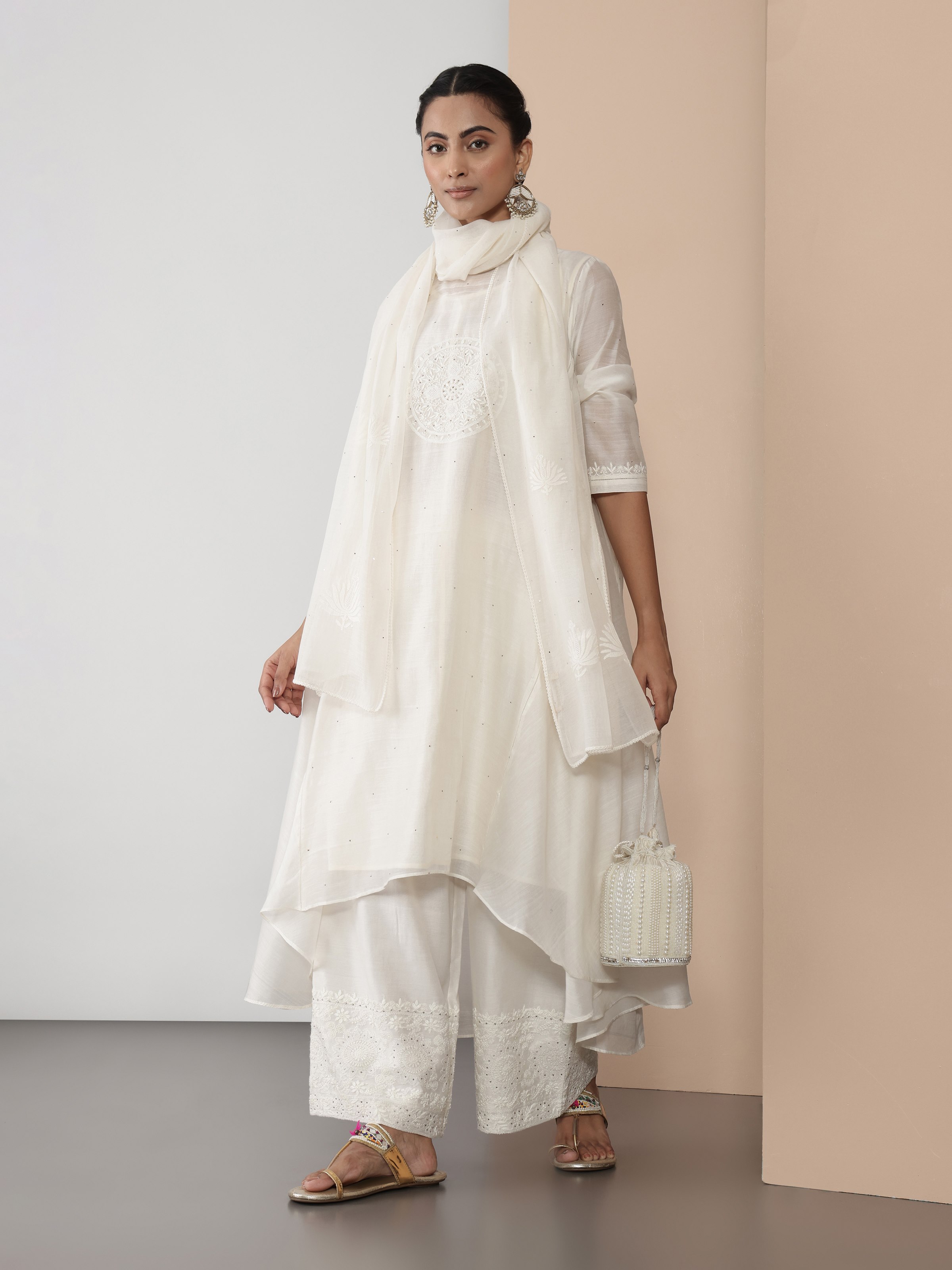 Lifestyle view of off-white Chikankari palazzo styled with a kurta for a graceful ethnic ensemble
