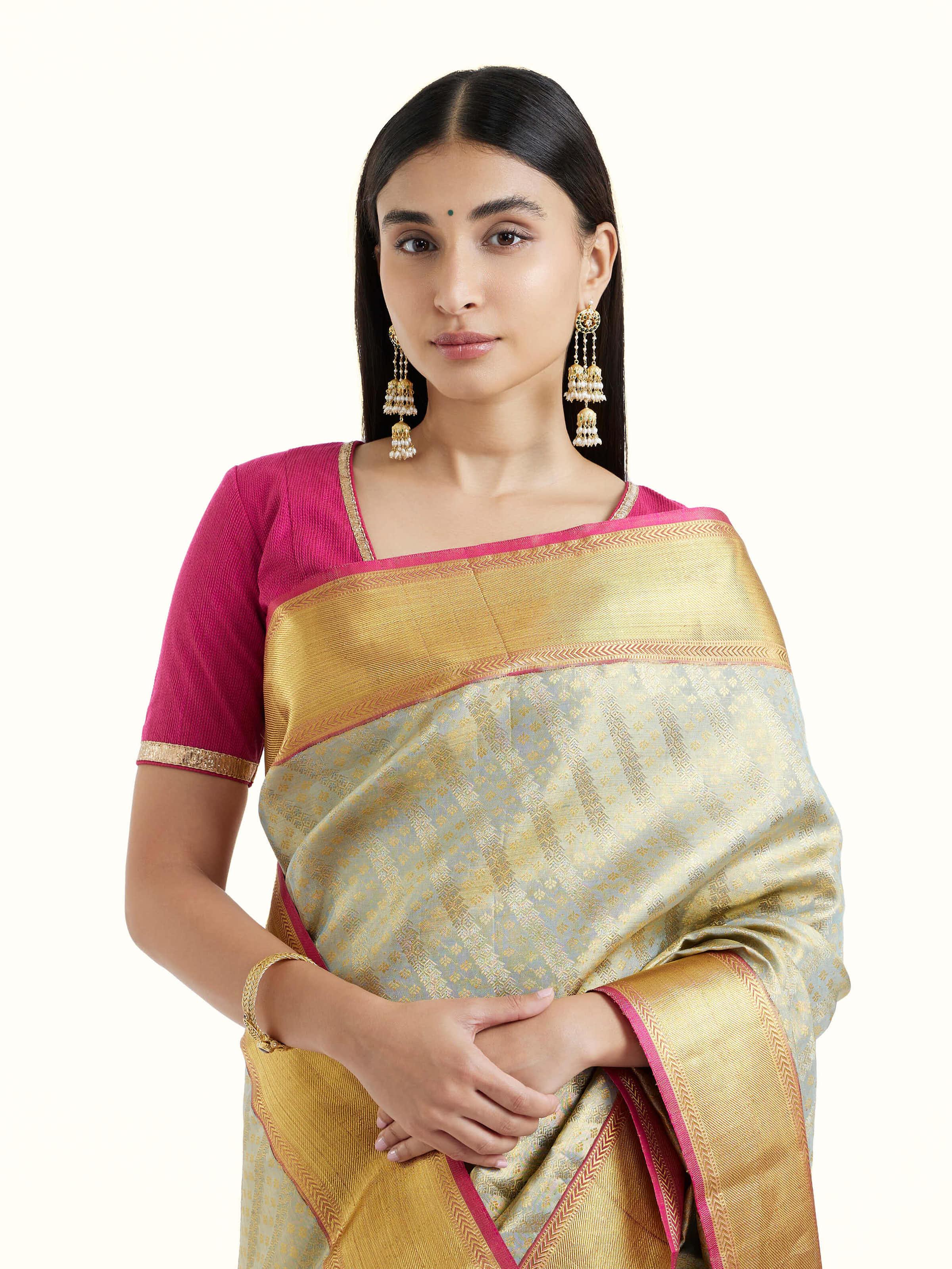 Angled view of pista silk Kancheepuram saree highlighting woven motifs