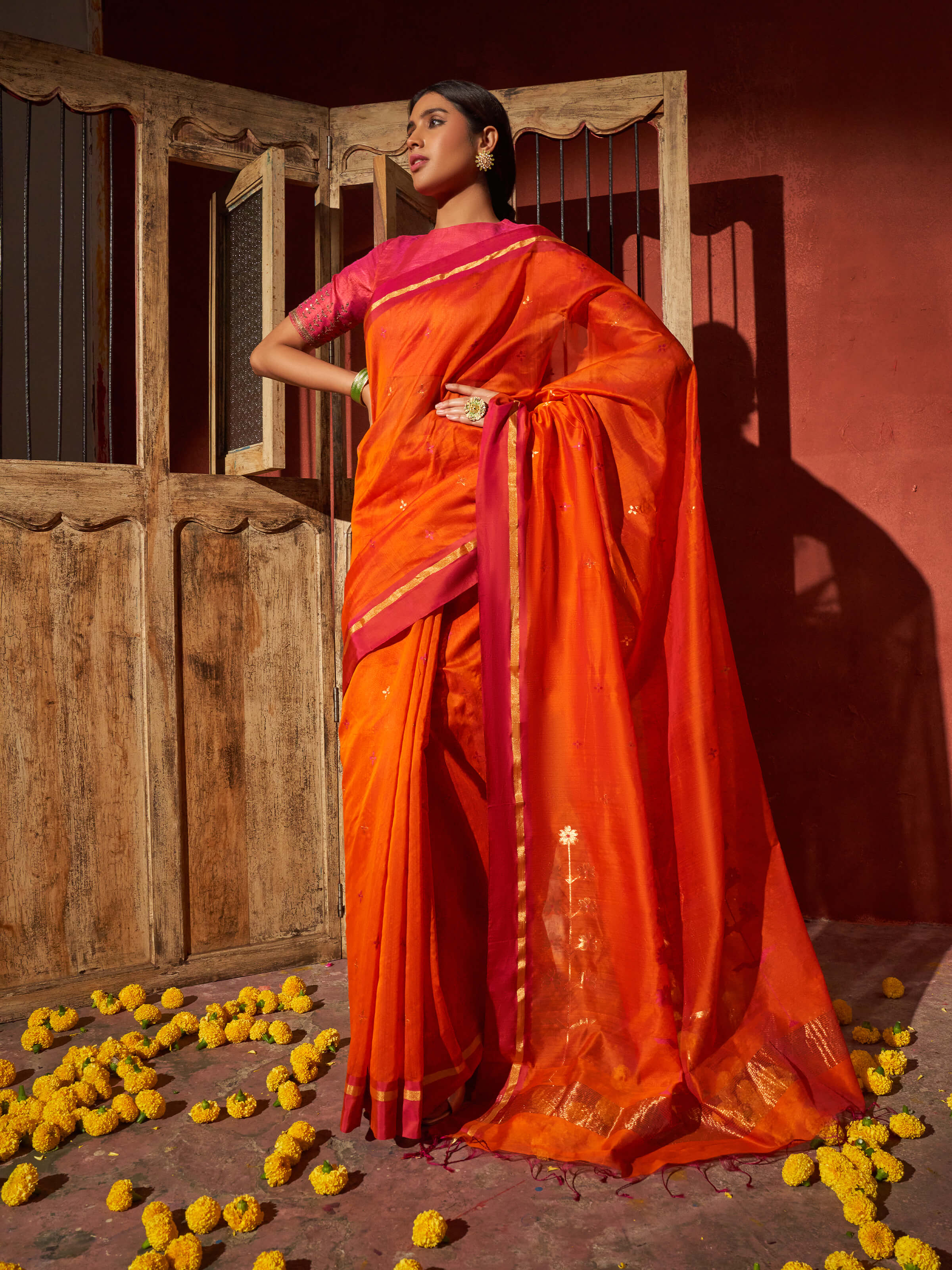 Angled view of rust mulberry silk cotton Chanderi saree emphasizing woven texture