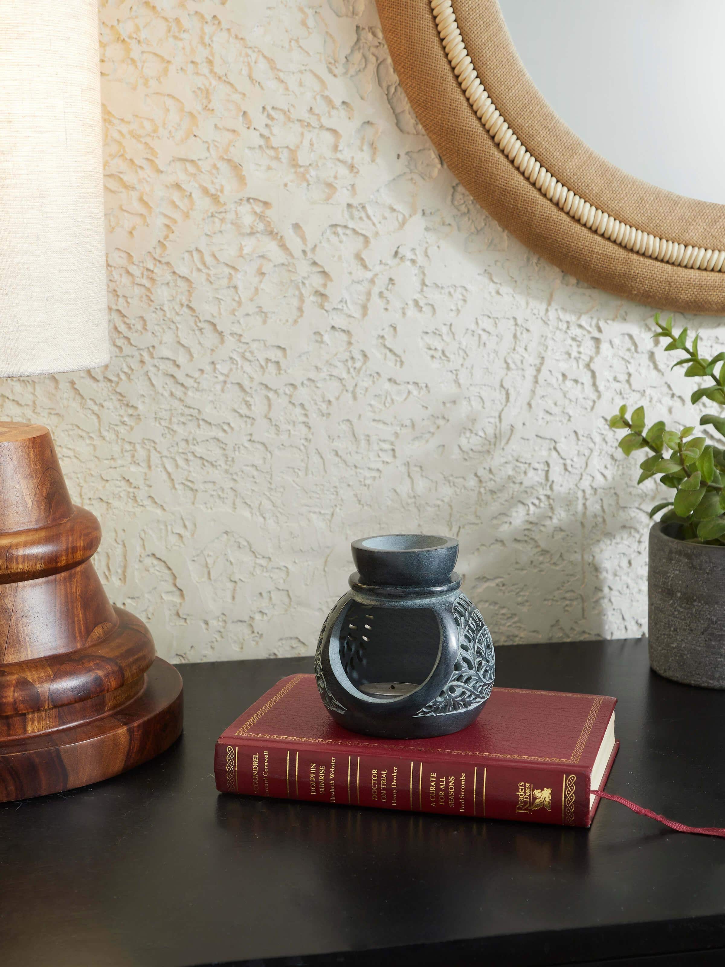 Side view of Carved soapstone aroma oil burner showing its intricate carving patterns and smooth finish
