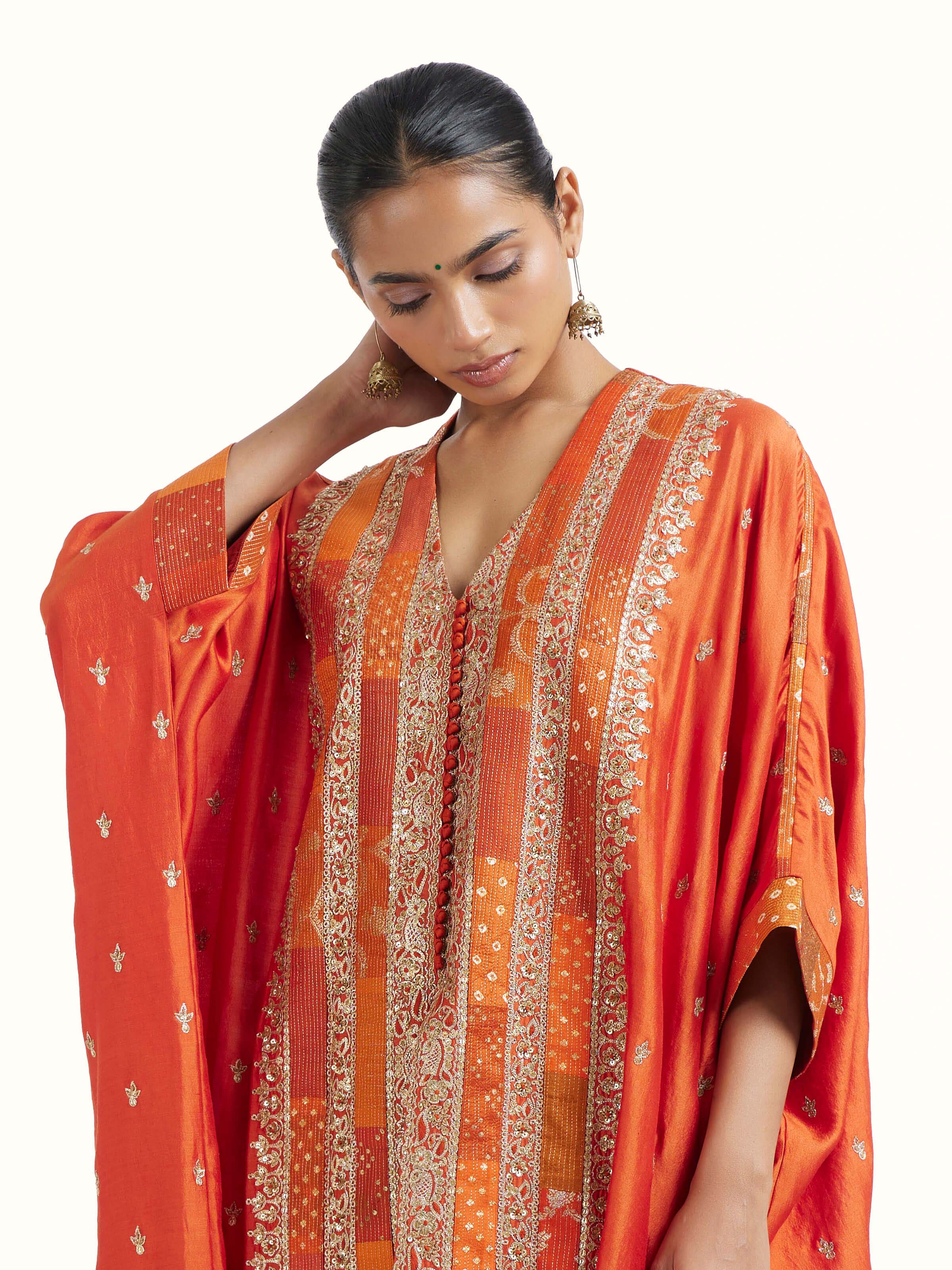 Angled view of rust silk hand embroidery co-ord set highlighting embroidery