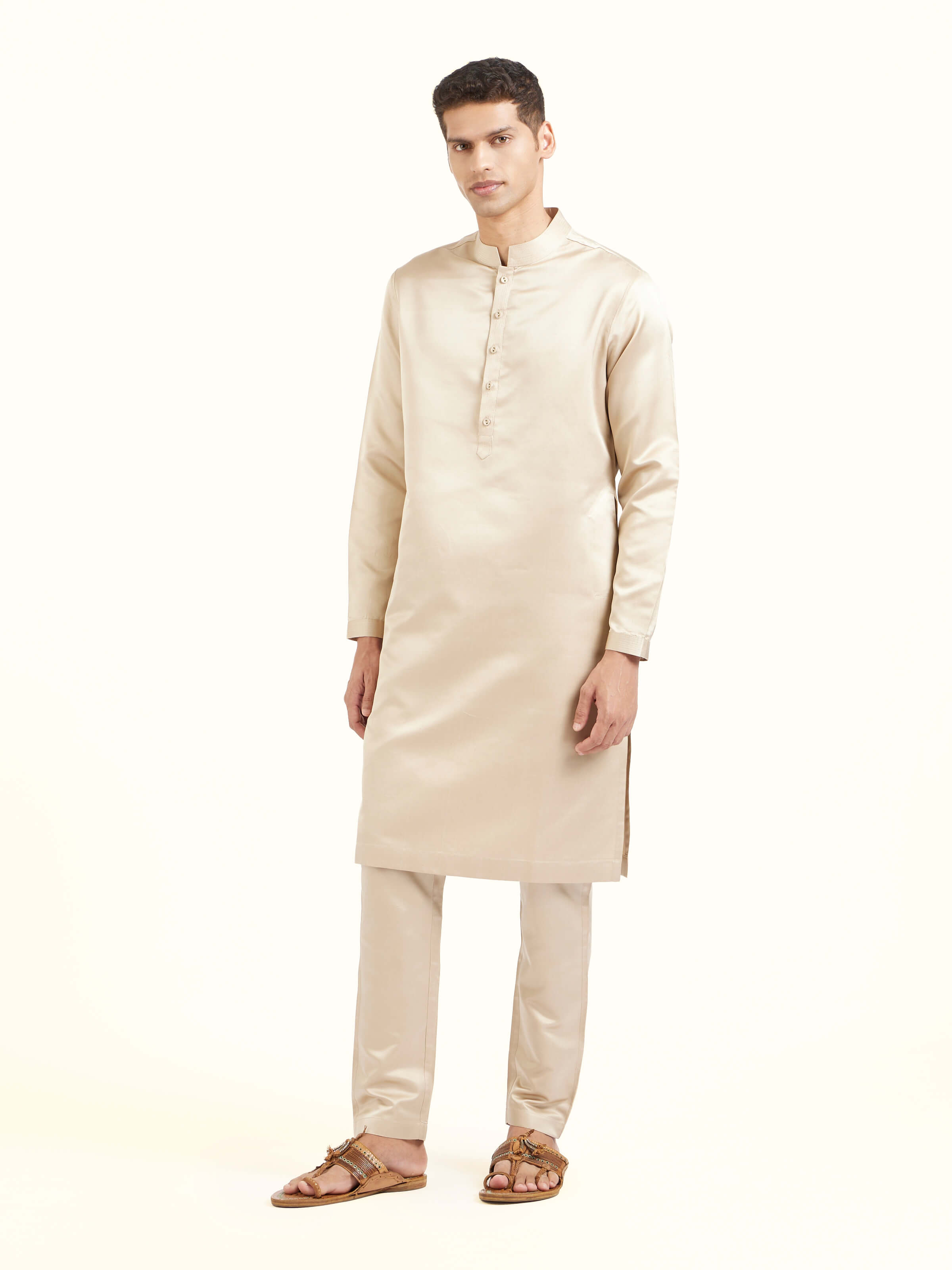 Side view of beige katan silk Banarasi long kurta churidar set highlighting kurta detailing and silhouette