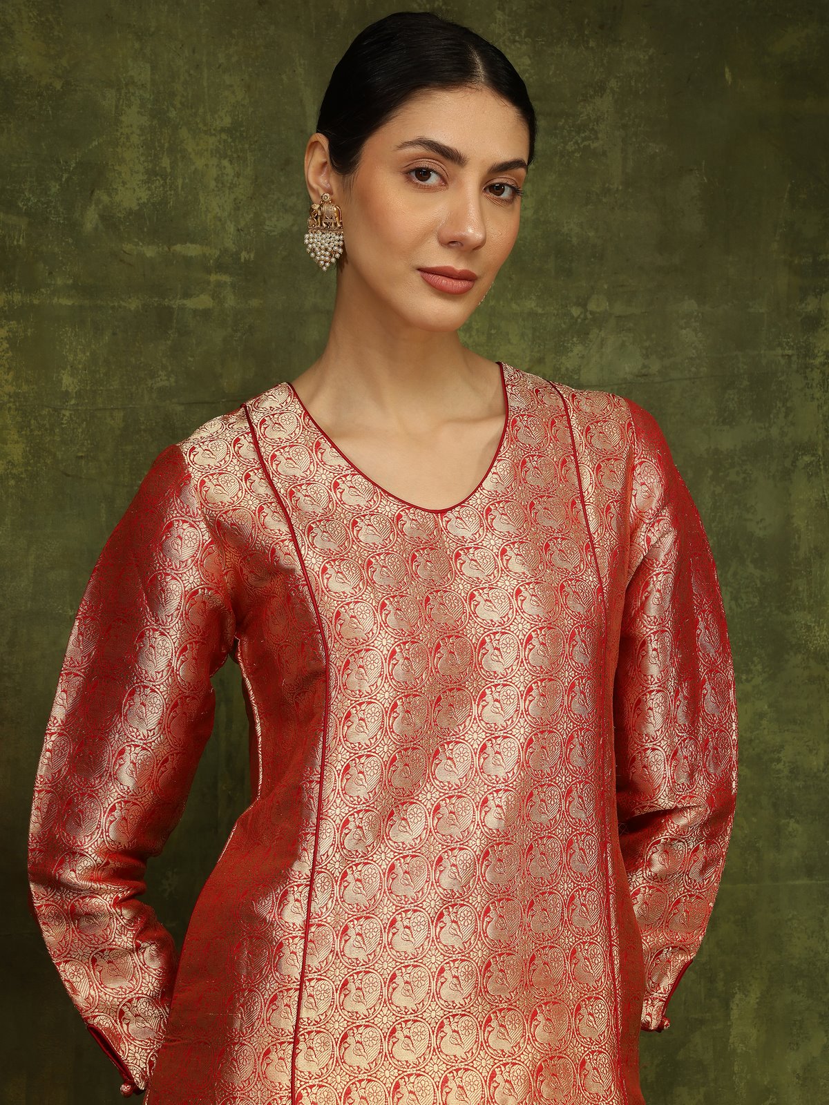 Angled pose of model in Red Silk Banarasi Kurta emphasizing neckline detailing and fabric sheen.