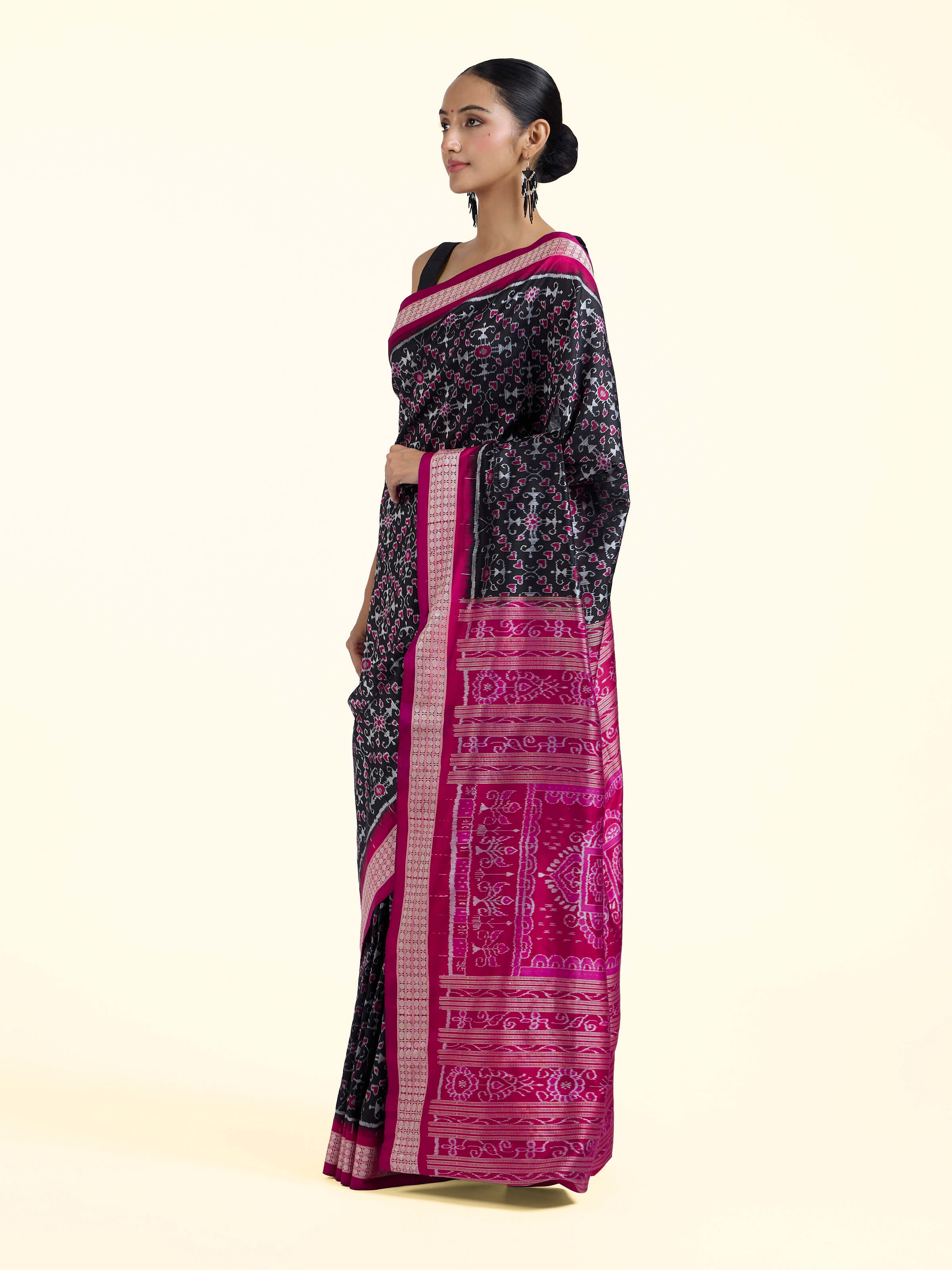Side view of black mulberry silk Bandha Odisha Ikat saree highlighting structured drape and fabric texture