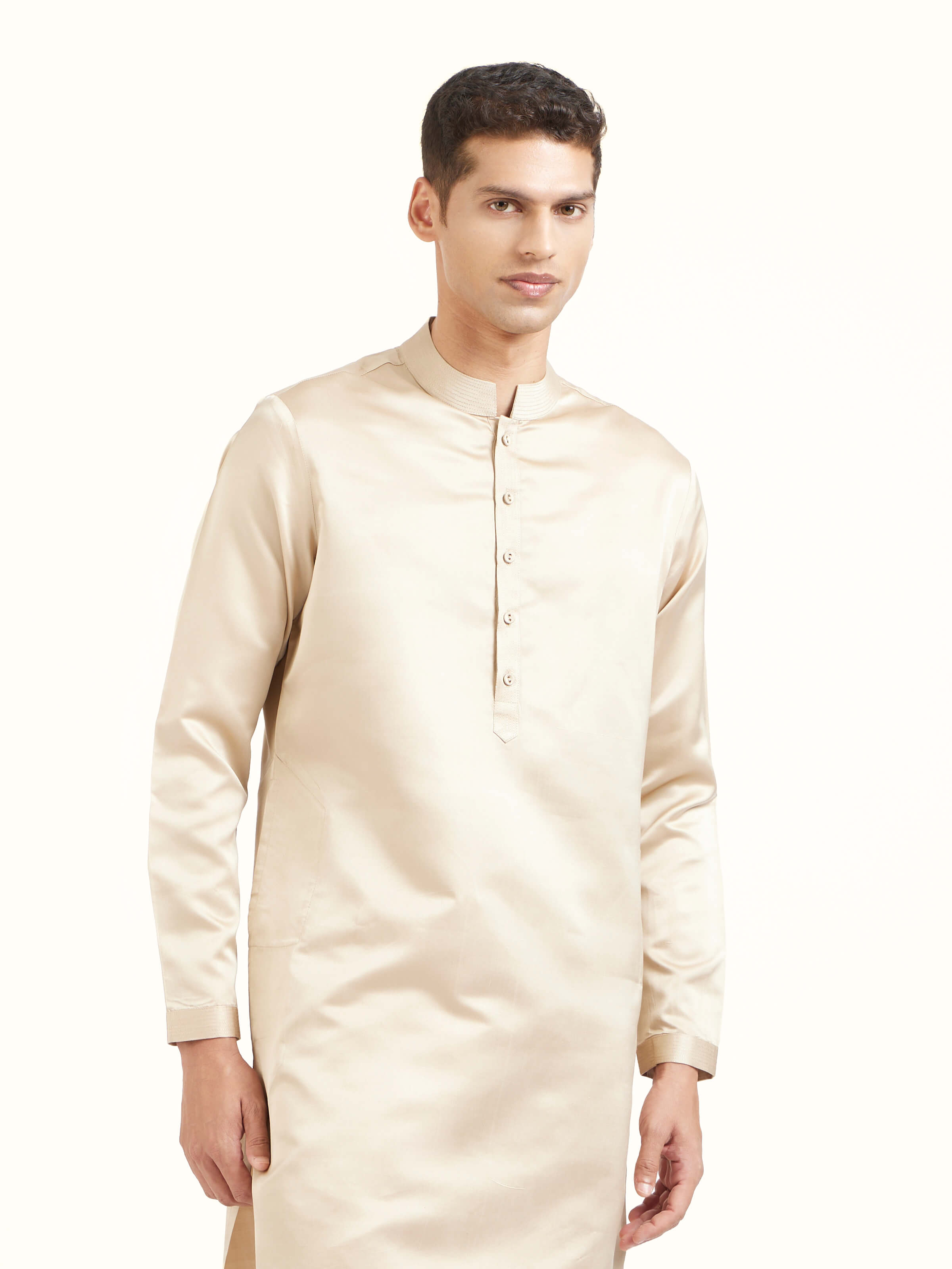 Angled view of beige katan silk Banarasi long kurta churidar set emphasizing rich Banarasi weave