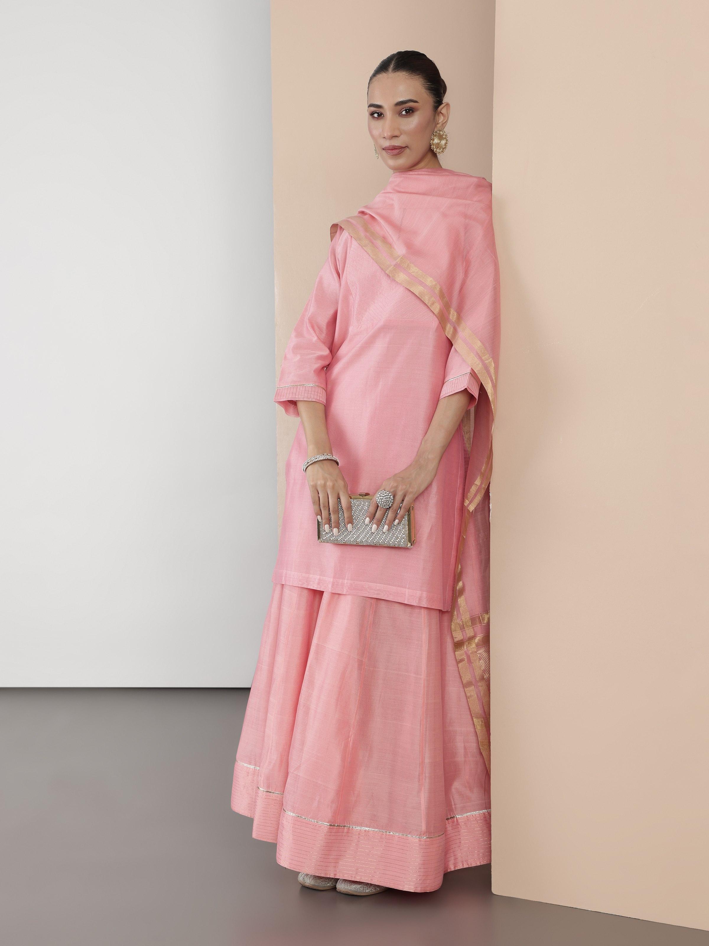 Angled view of pink cotton silk Chanderi tunic highlighting fabric texture and cut.