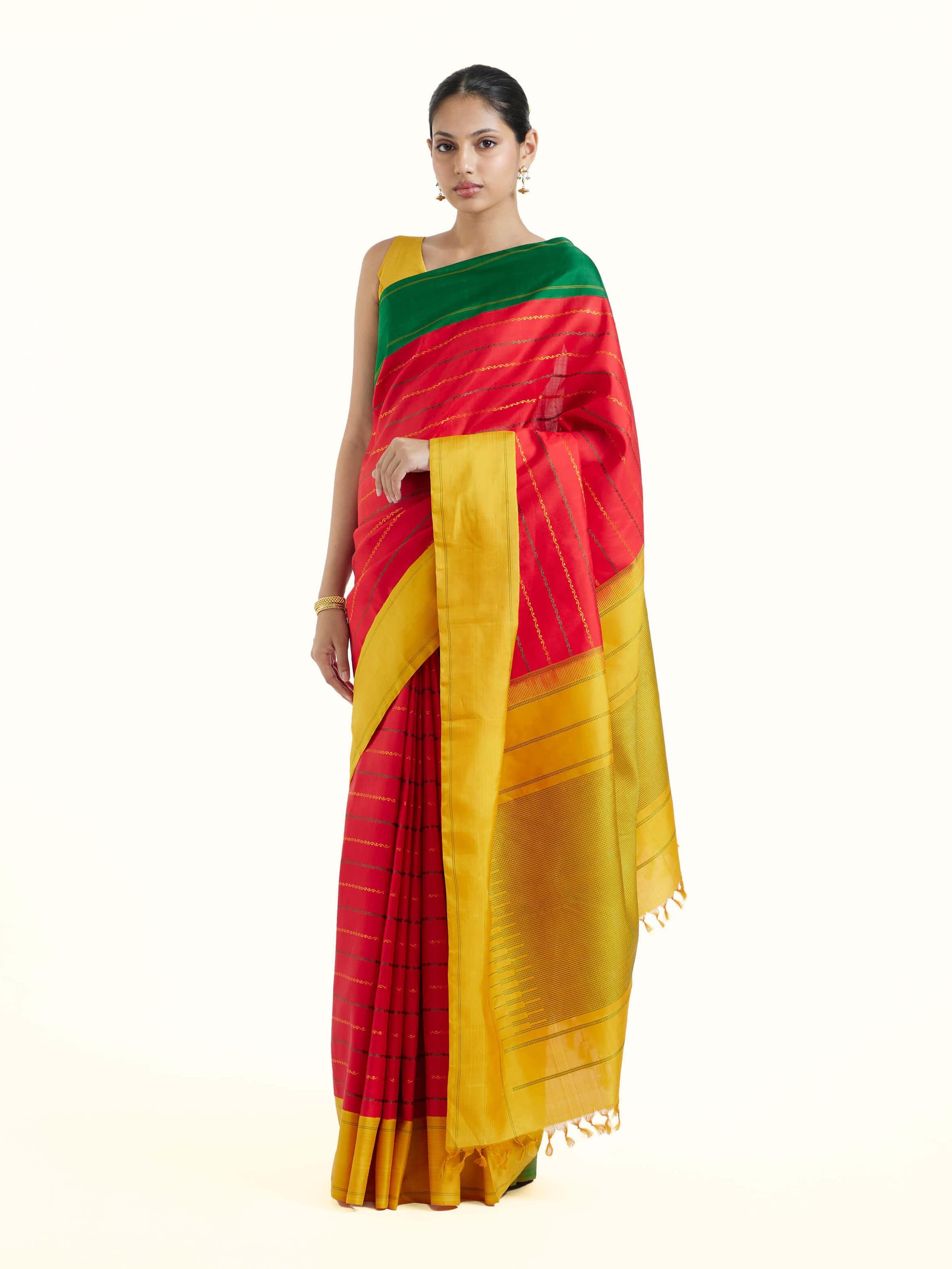 Side view of red silk Kancheepuram saree showcasing graceful drape
