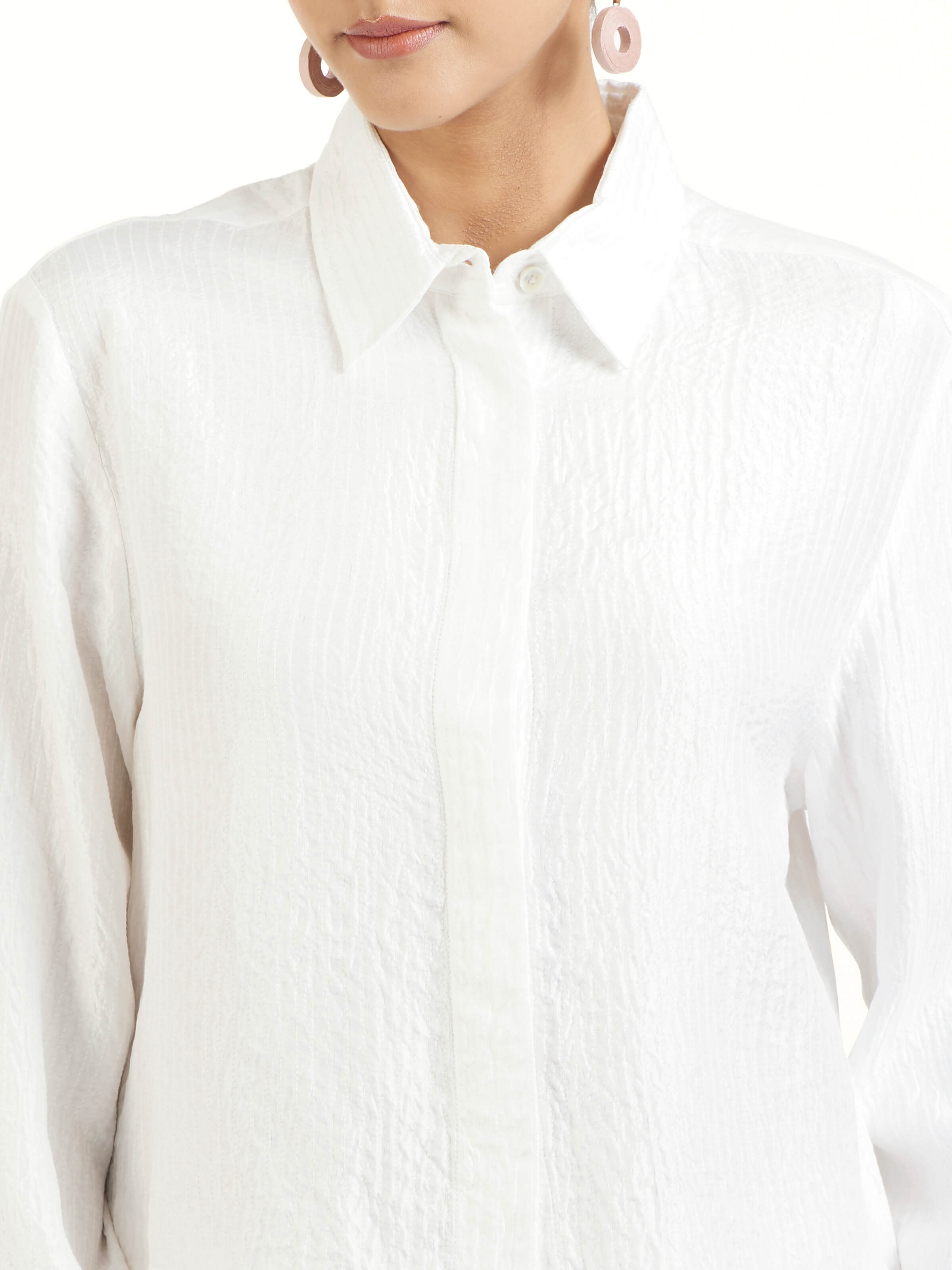 Detail view of ivory quilted silk shirt showing silk surface