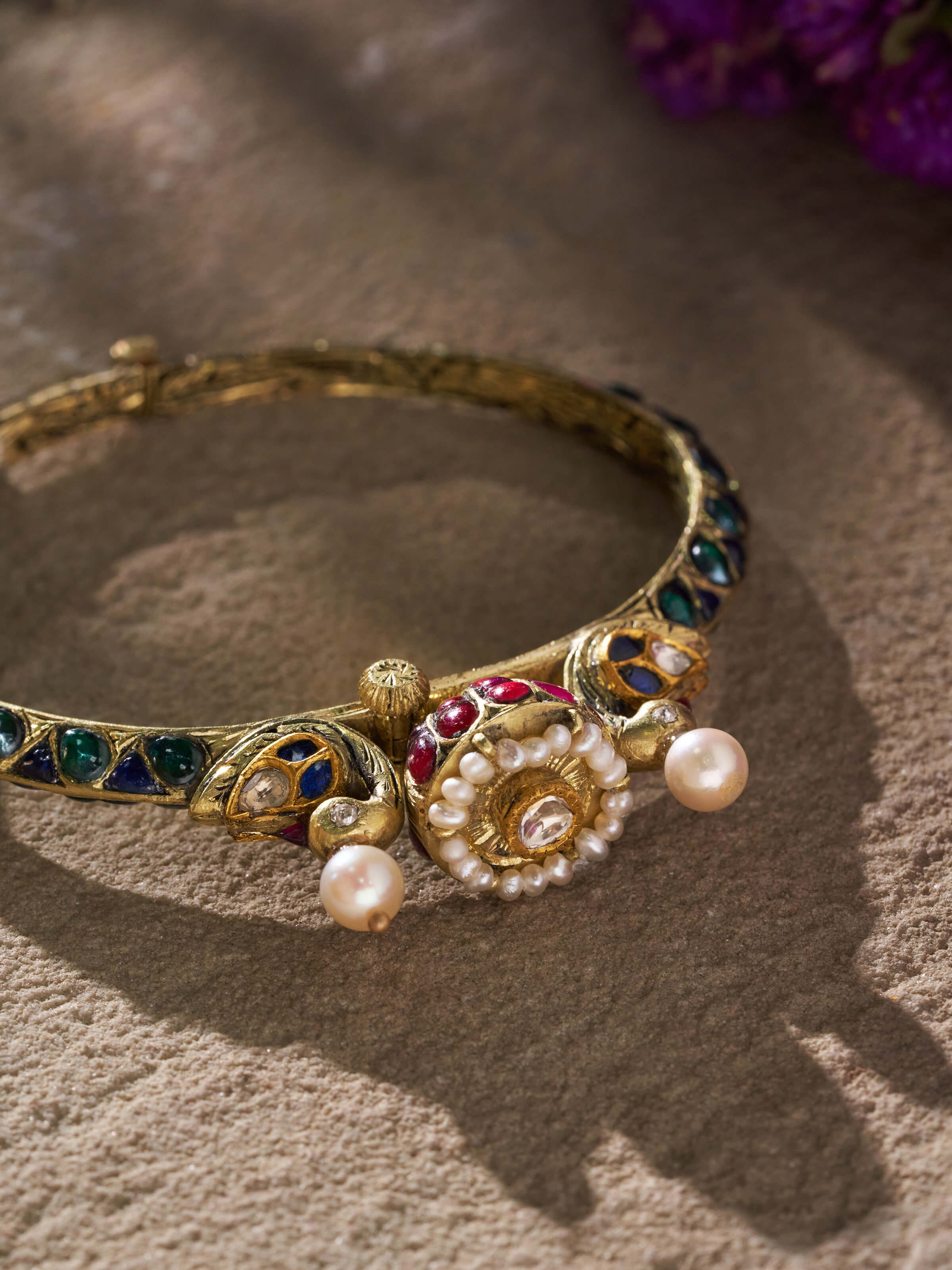 Angled view of Partash 18 karat gold bangle highlighting its detailed texture and high-quality finish