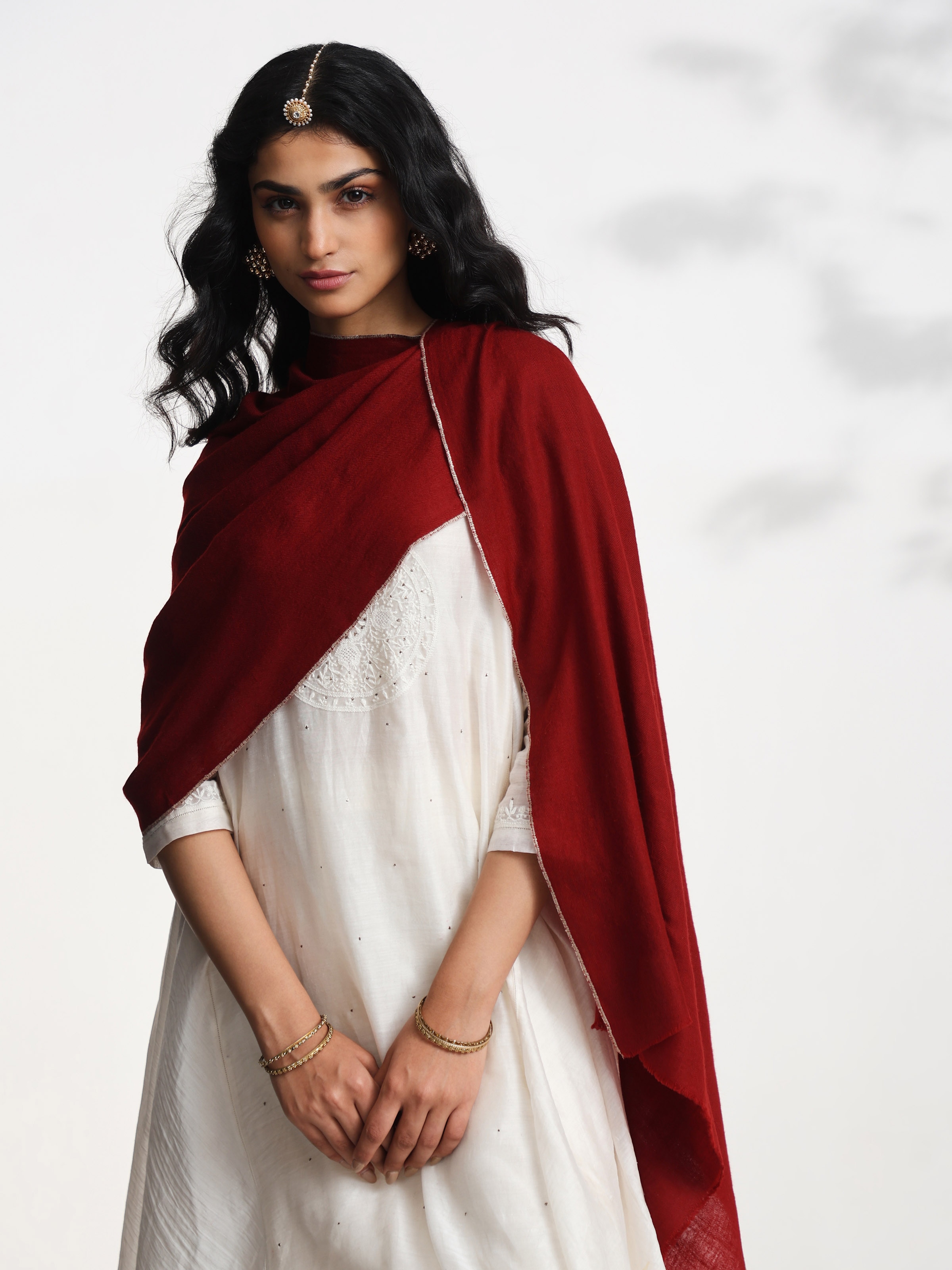 Angled view of maroon cashmere kaaj embroidered handwoven stole highlighting kaaj work