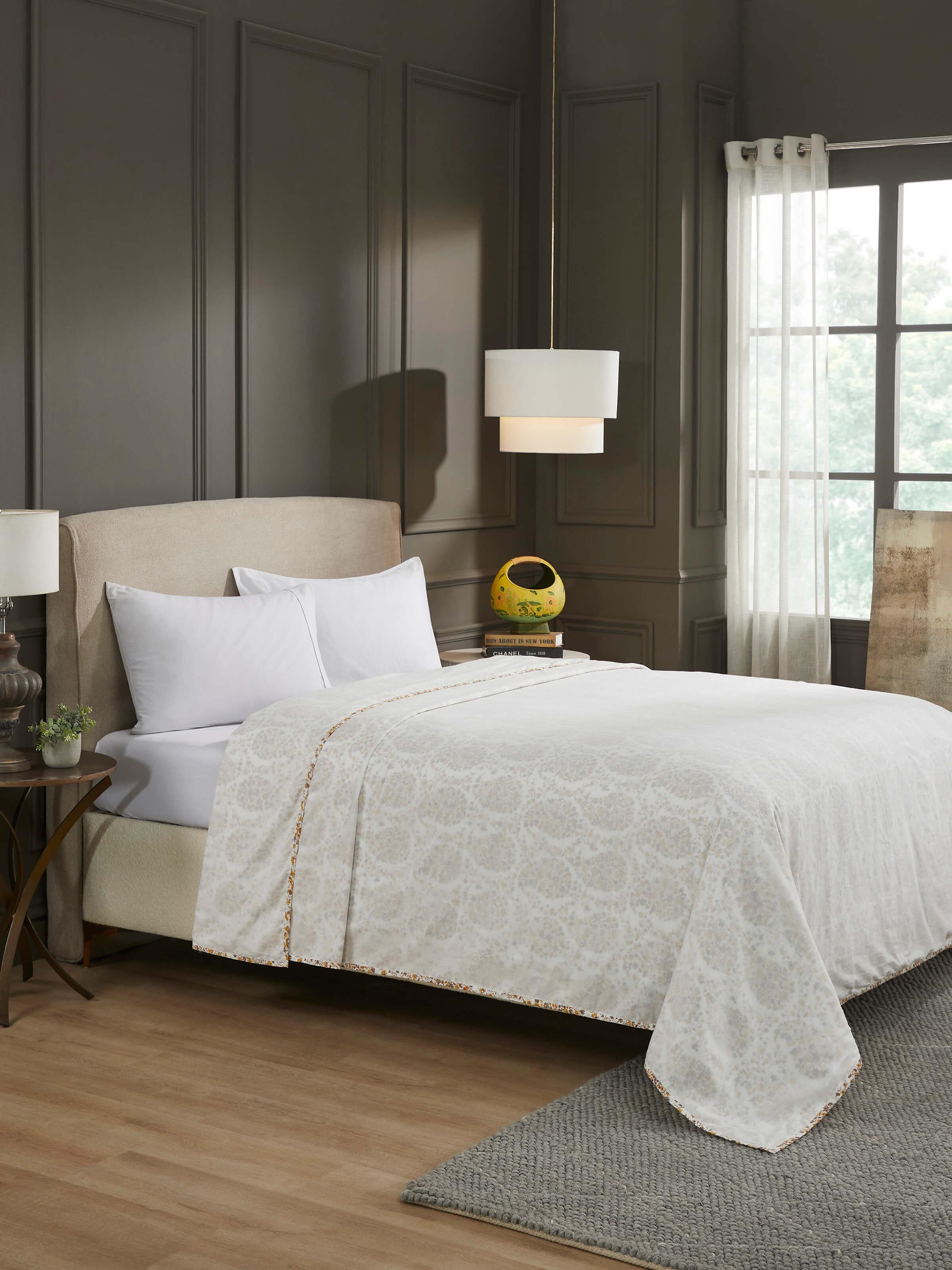 Lifestyle shot: Styled red paisley cotton double dohar on bed showcasing vibrant print and artisanal touch.