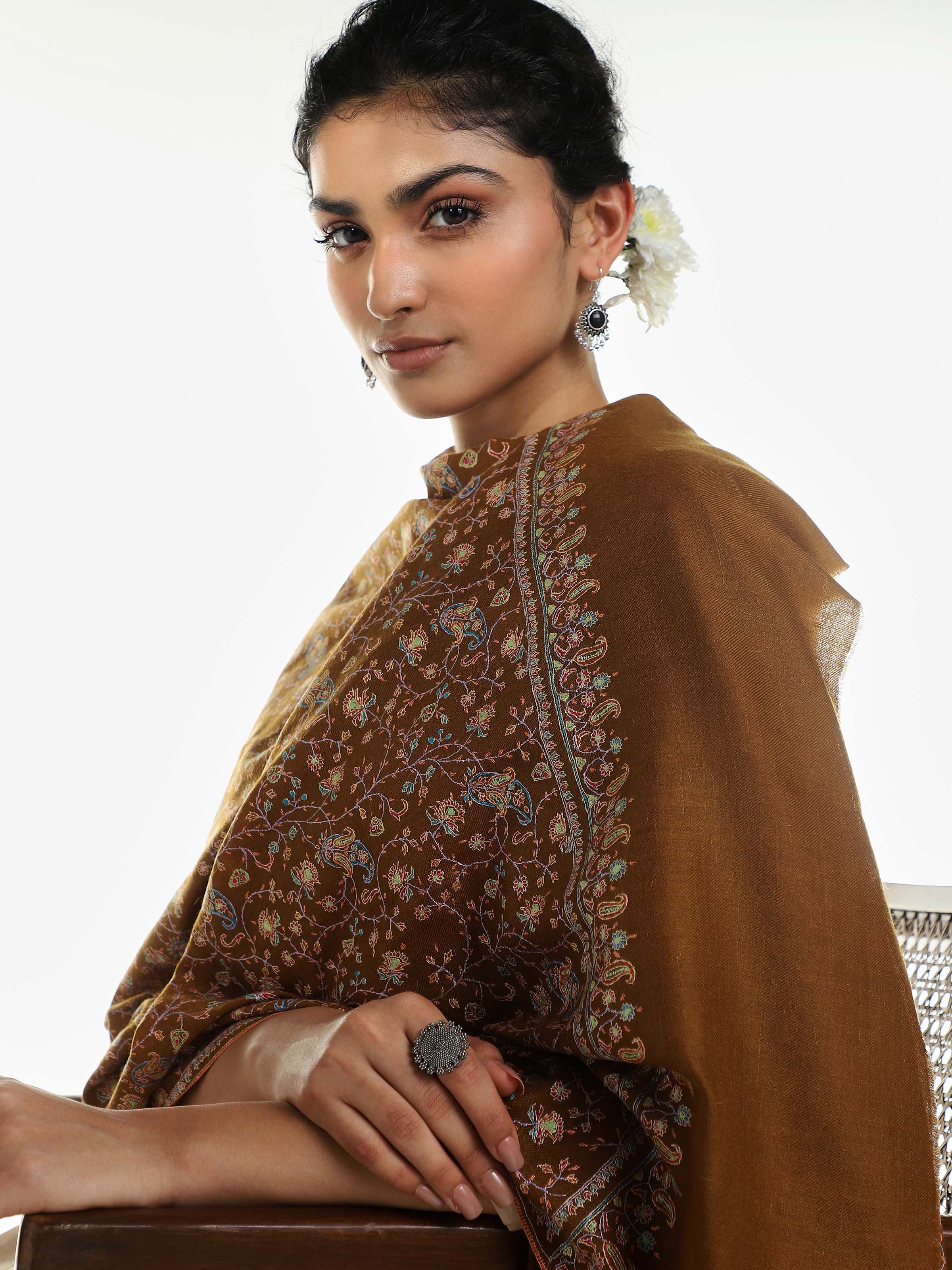 Detail view of brown neemjali sozni embroidered shawl showing fine craftsmanship