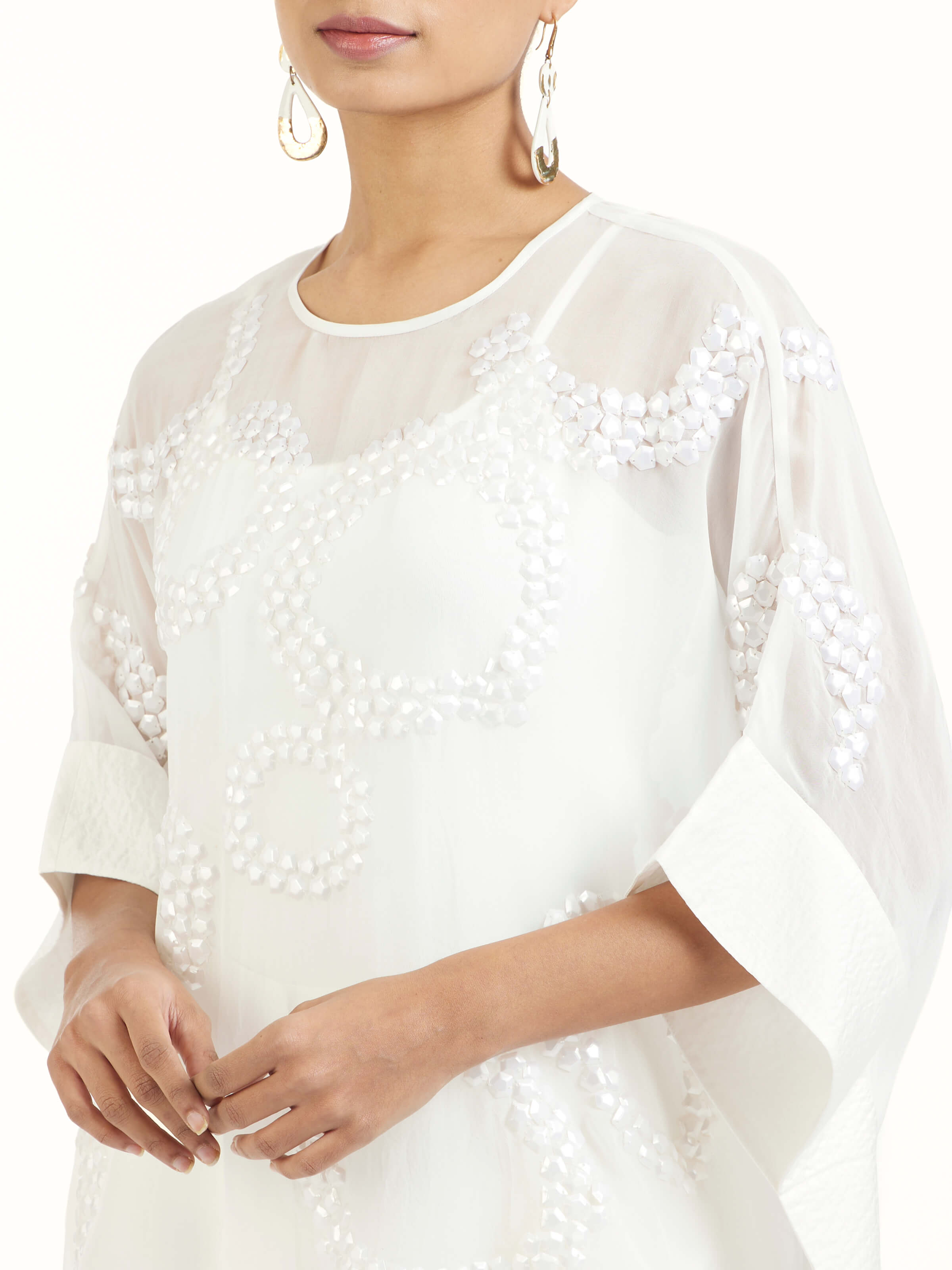 Detail view of ivory hand embroidered organza kaftan revealing fine craftsmanship