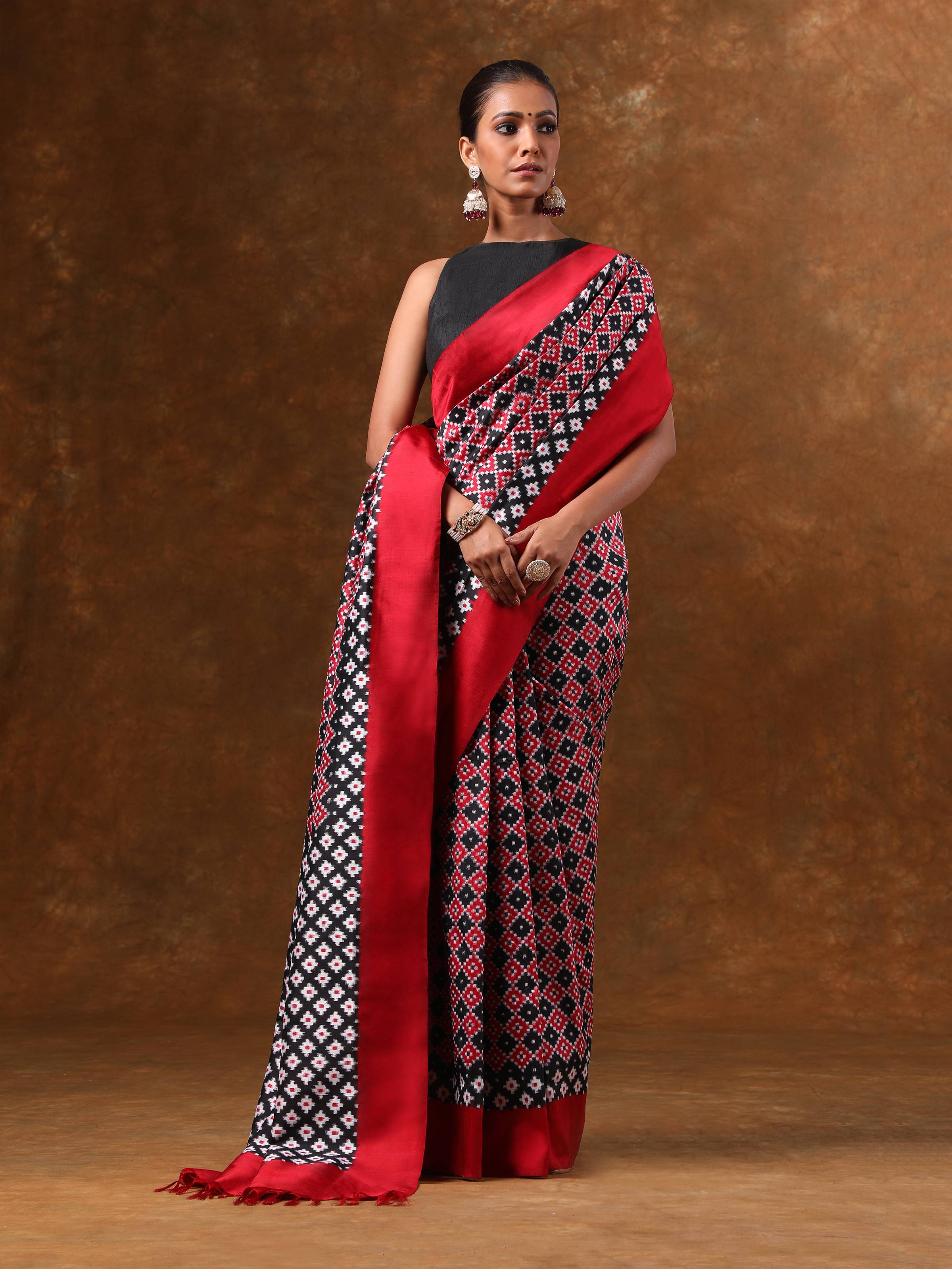 Side lifestyle view of black Telia Rumal saree showcasing drape and border