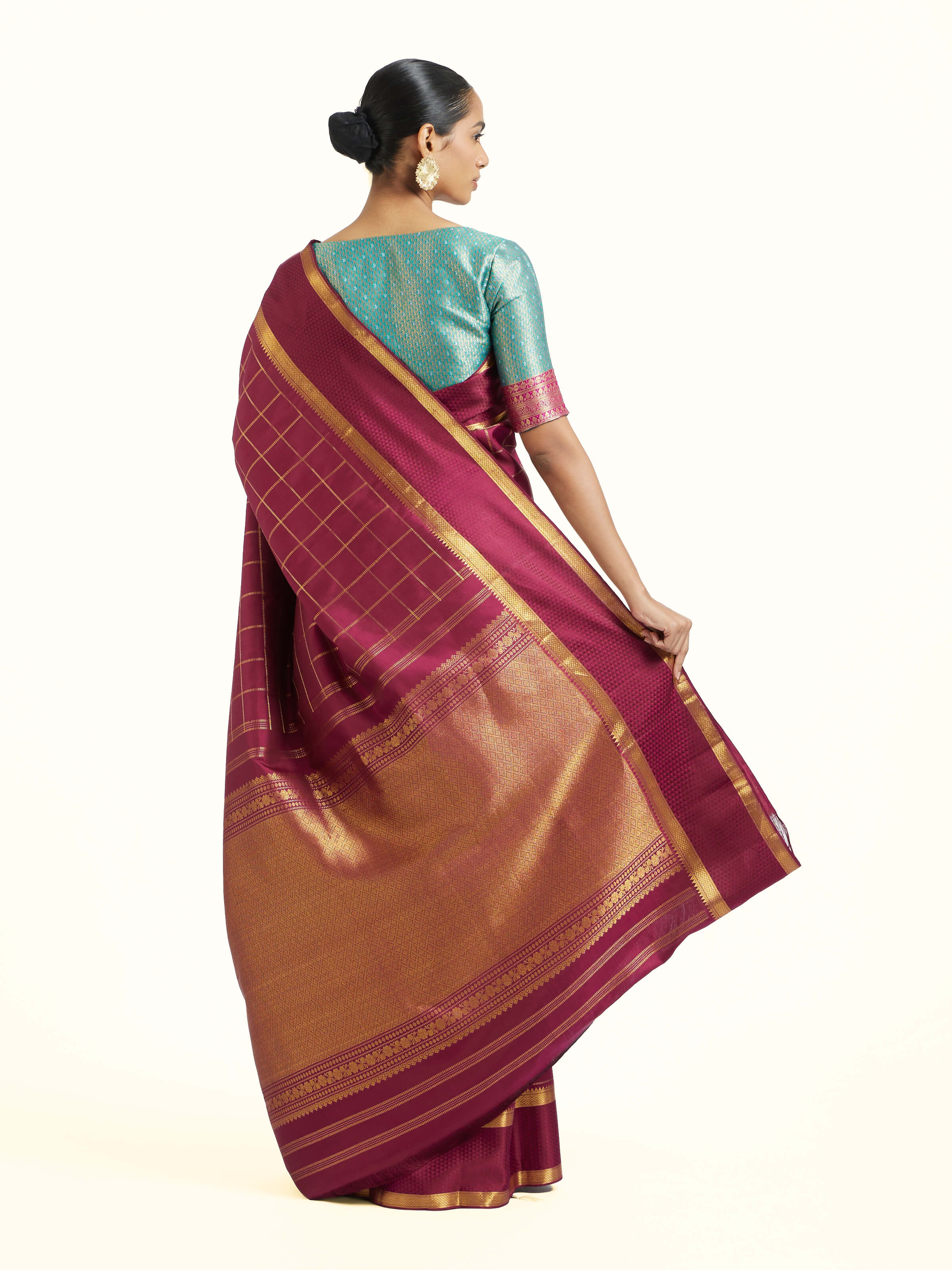 Back view of burgundy silk Kancheepuram saree displaying ornate pallu design