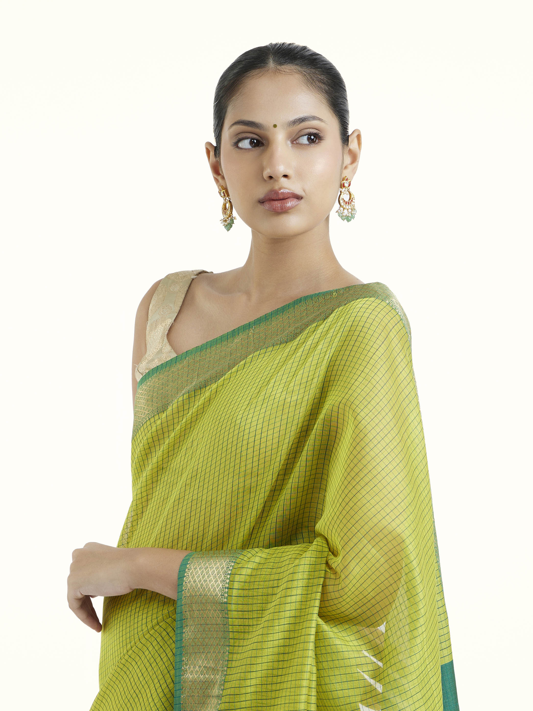 Angled view of green cotton silk Maheshwari saree emphasizing classic Maheshwari weave