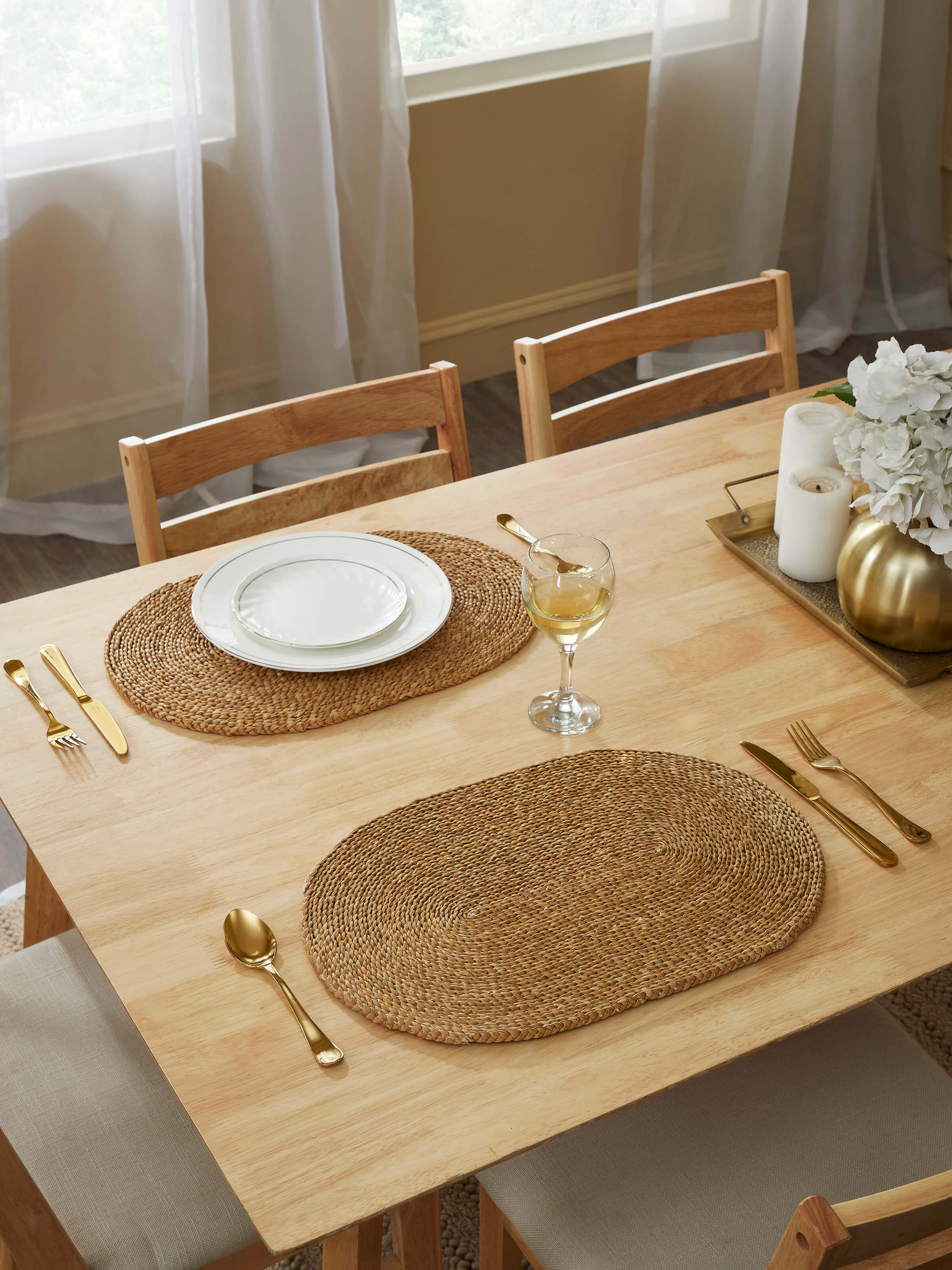 Close-up of Vritti brown solid oval natural fibre trivets, focusing on the intricate natural fibre weave.